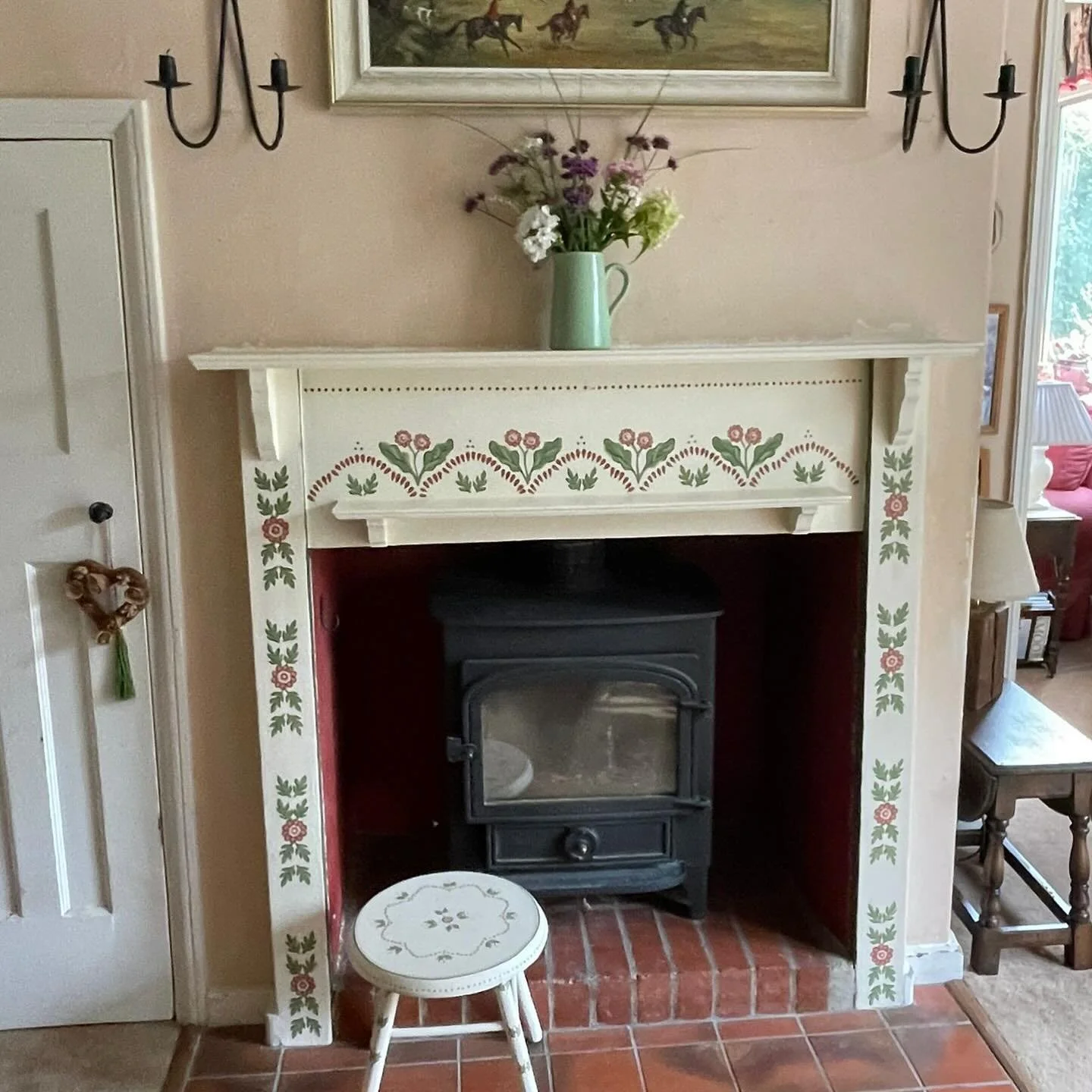 A fun fireplace and co-ordinating stool recently  hand-painted in Surrey