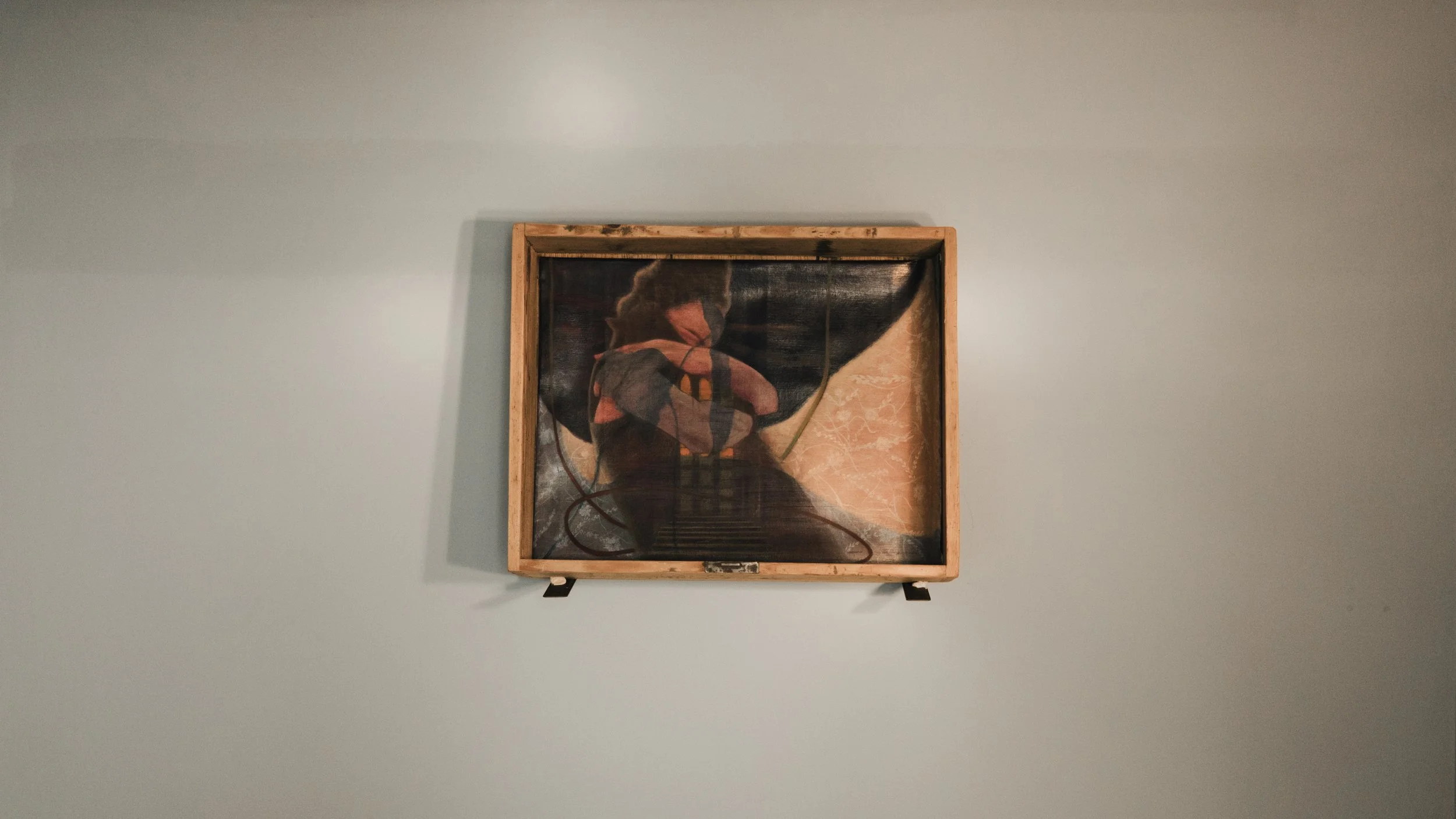 Further up,  installation, a wooden drawer  made by the artist’s great-grandfather  around 120 years old  restored and used as a frame for the oil painting on canvas by Andrada Lolu. Photo by Daniel Truța.