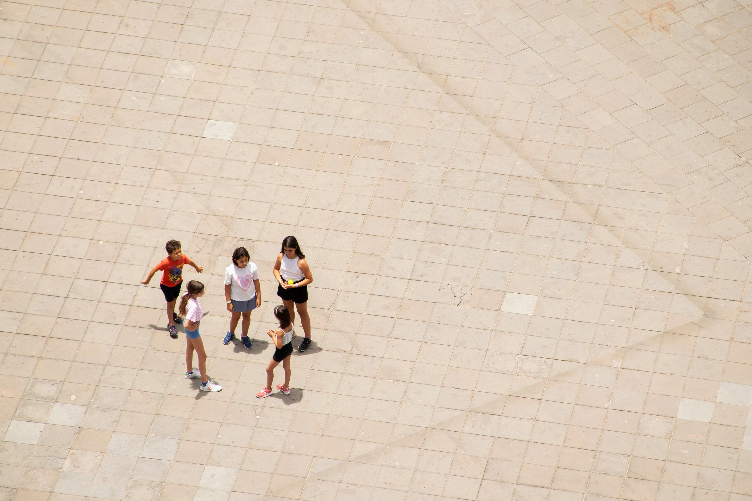 children on a town square from above