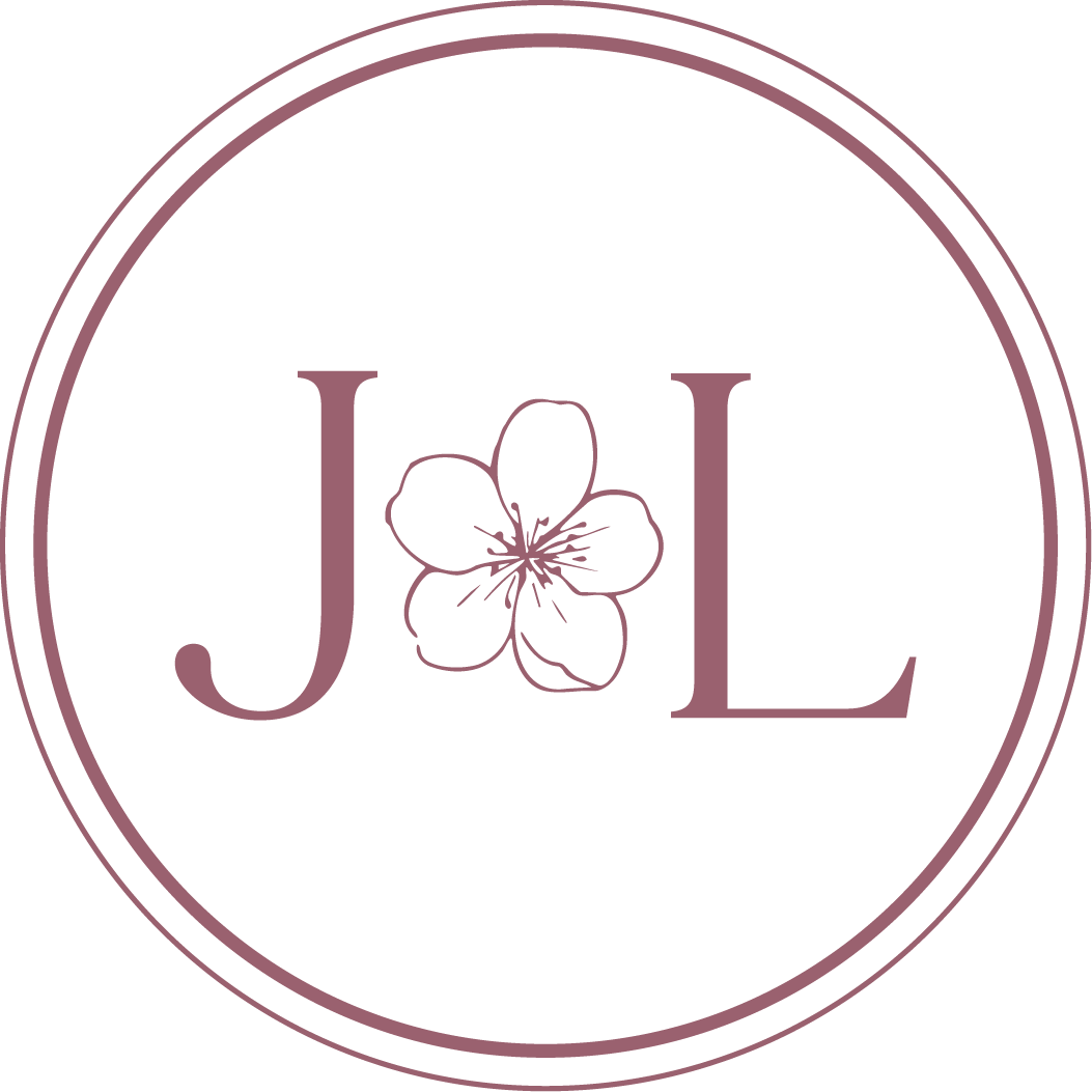 A black circular logo with a purple outline and the word 'JOL' in purple letters. The letter 'O' is replaced with a purple flower in the center.