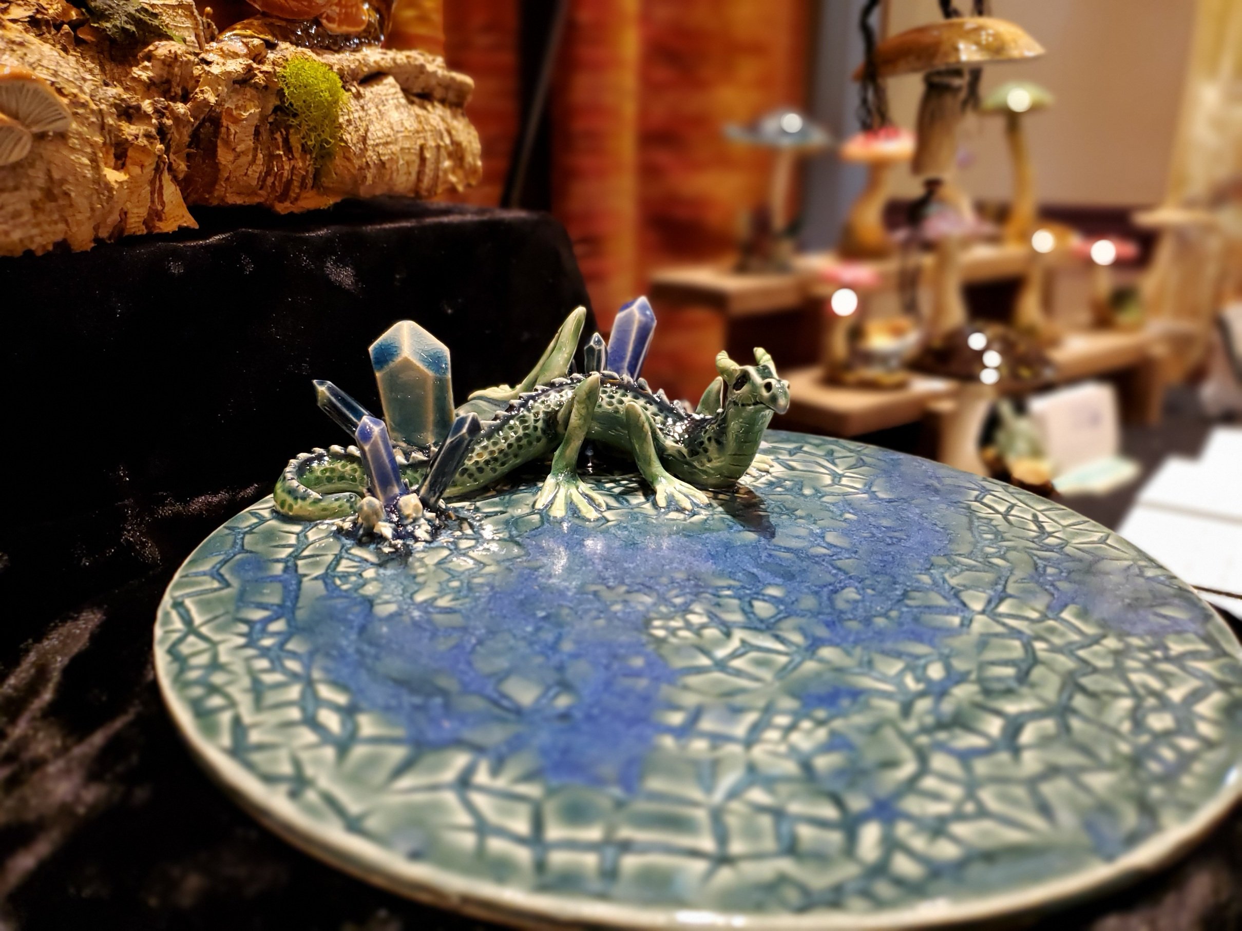 Detail of a ceramic dragon atop a lid with ceramic crystals