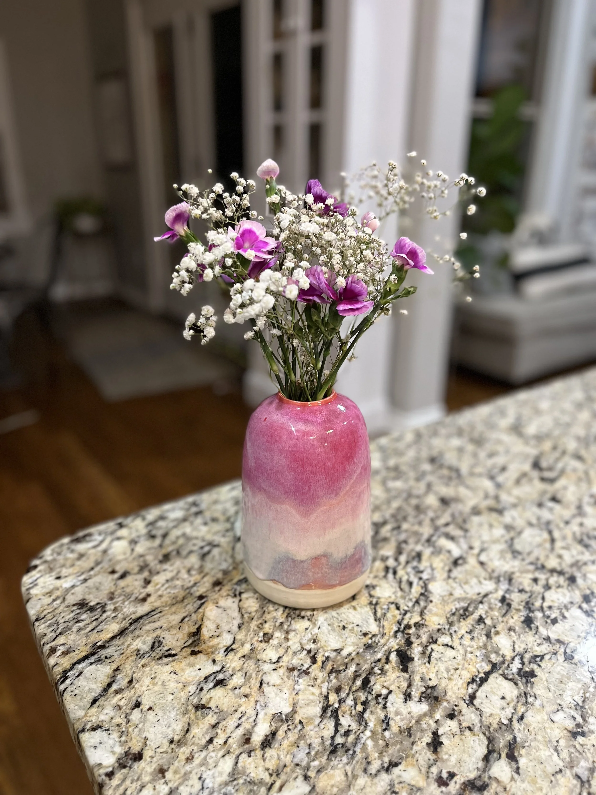 Pink and white ceramic vase with flowers