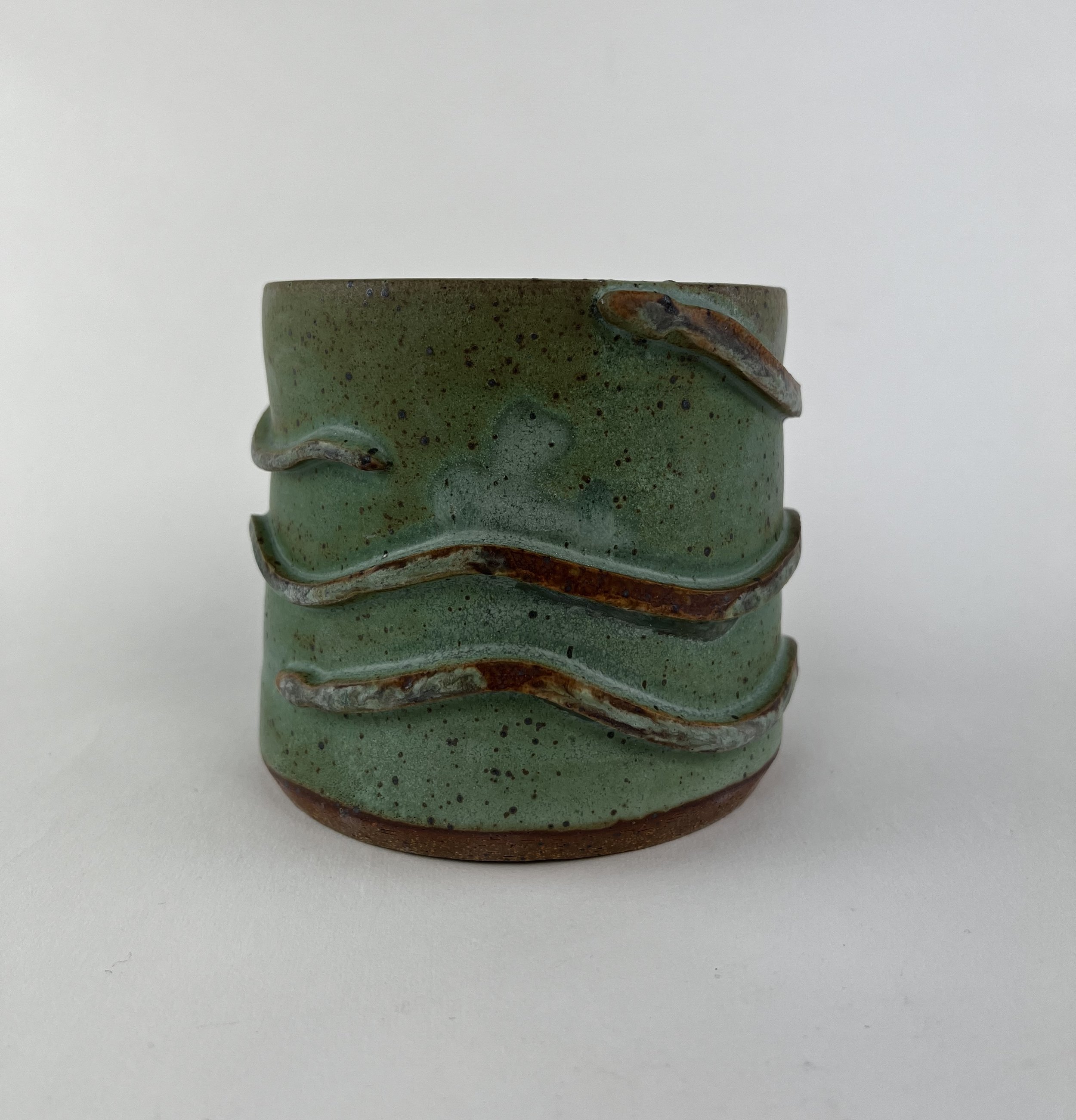 green ceramic pot with a snake wrapped around it