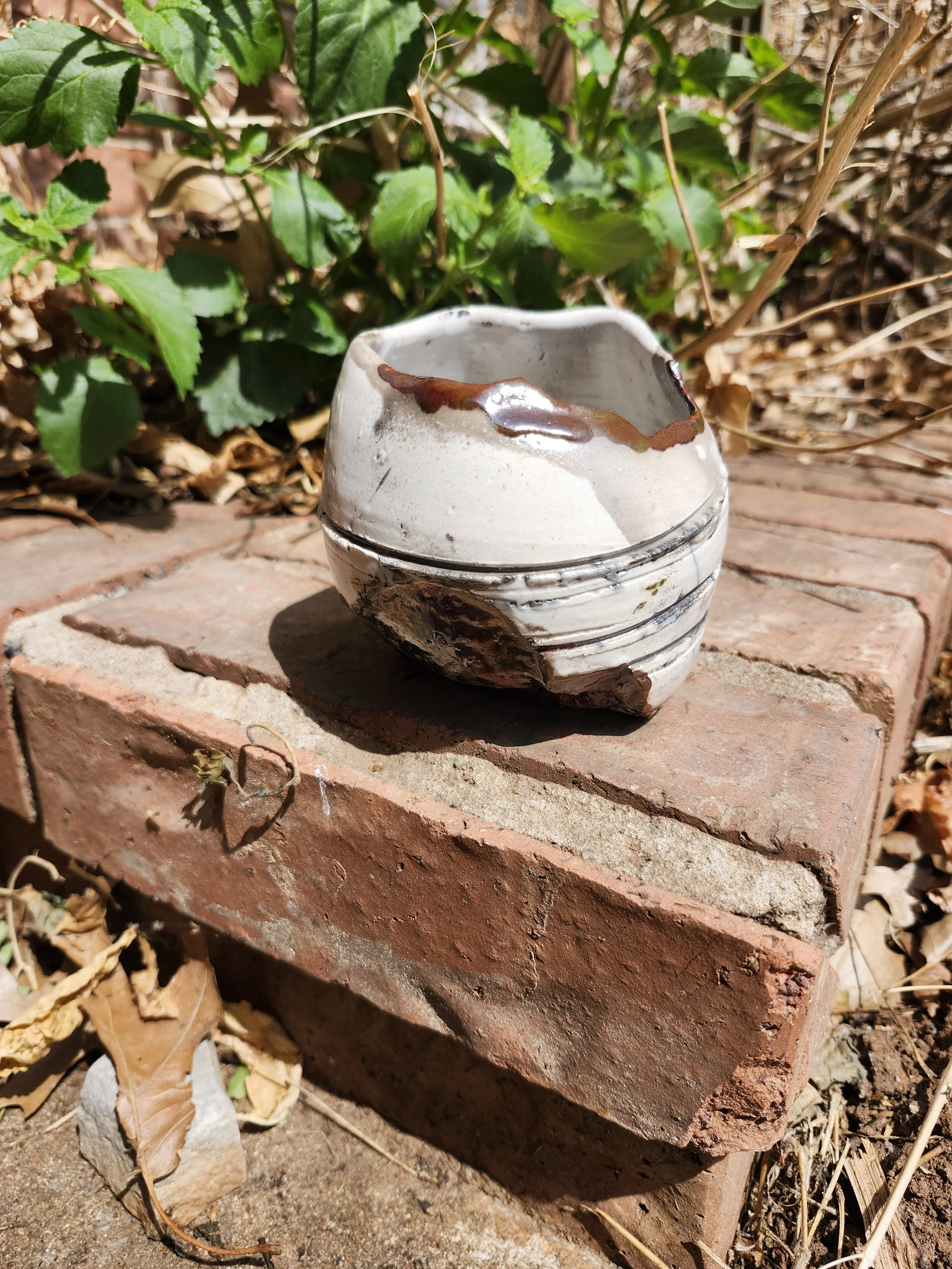Small white vase with broken edges