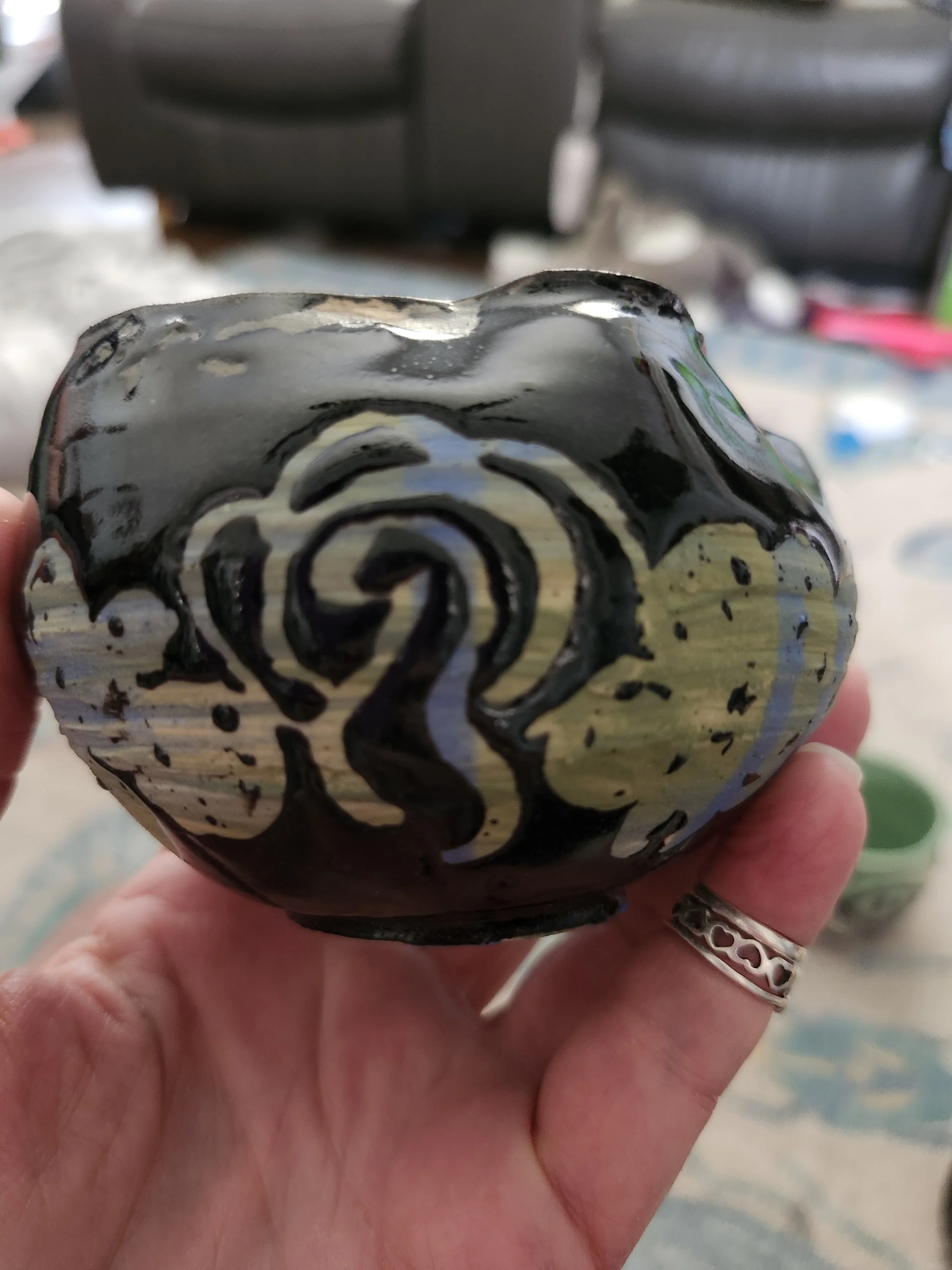 Small vase glazed in blues and greens with glossy black overlay