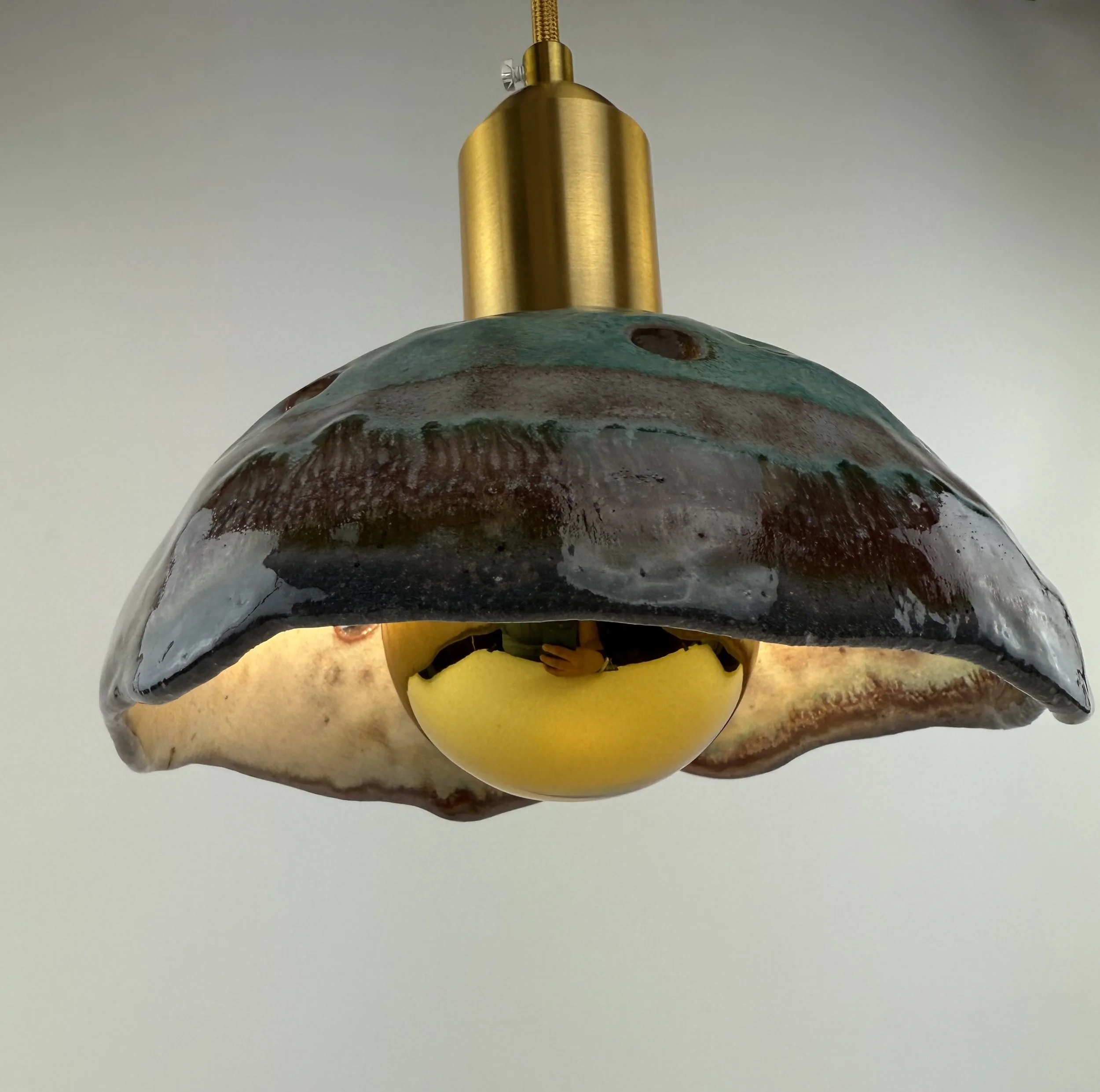 ceramic light fixture with brass attachment