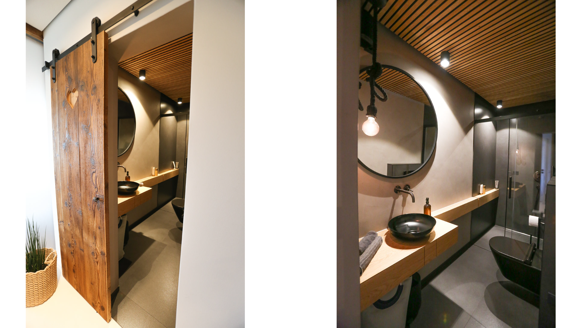 Moderner Badezimmerblick mit dunklen und Holz-Elementen, rundem Spiegel, schwarzer Waschschüssel, Handtüchern und Toilette, beleuchtet von Deckenleuchten, ein heller Wandbereich ist sichtbar.