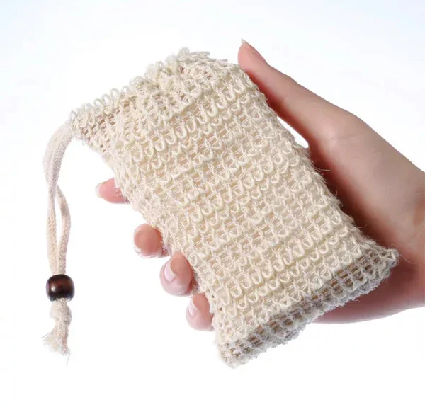 Sisal soap saver pouch made from natural plant fiber, used to hold a bar of soap for exfoliating lather and hanging to dry in the shower with drawstring closure.