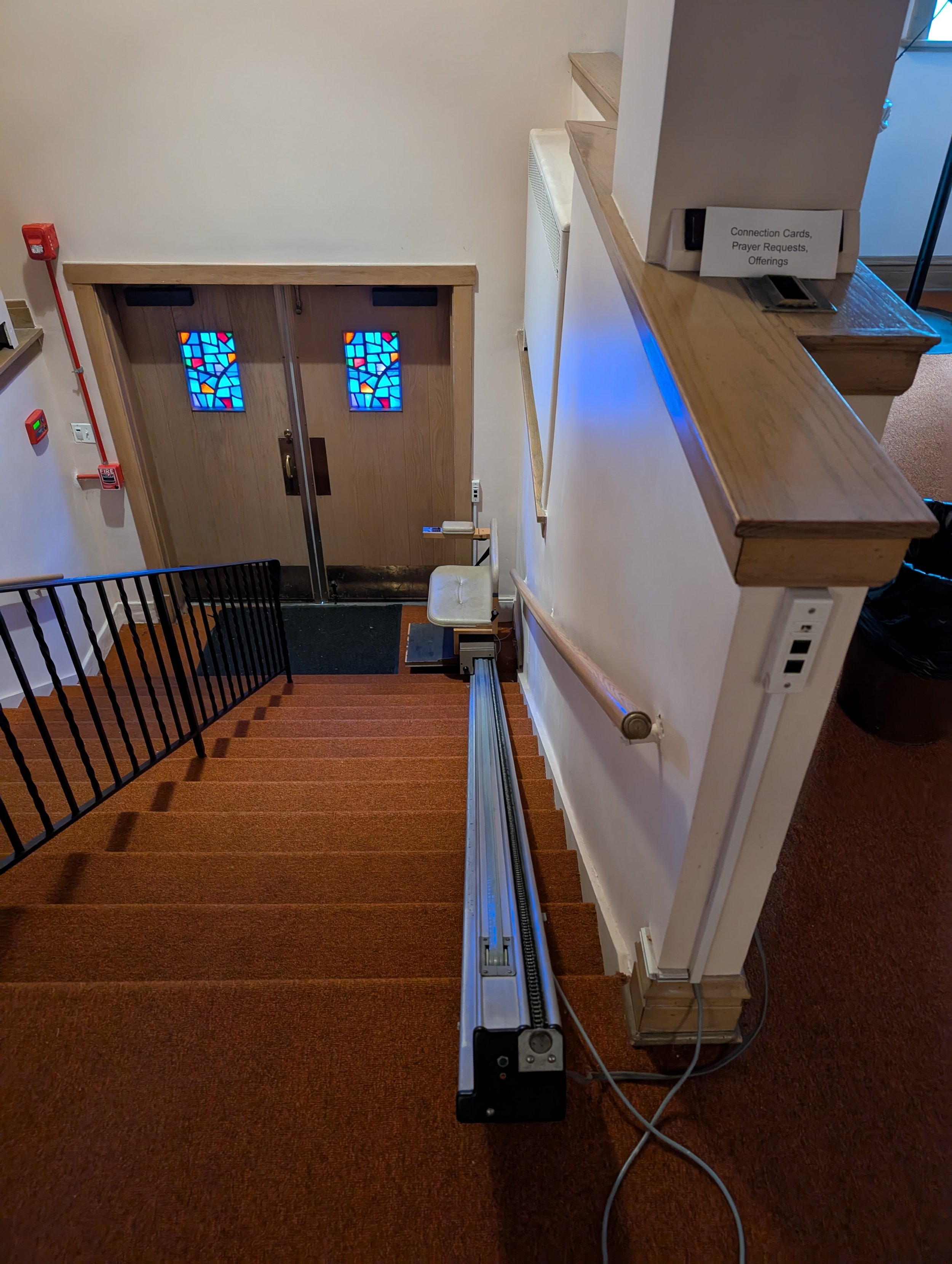 Staircase featuring chair lift at bottom.