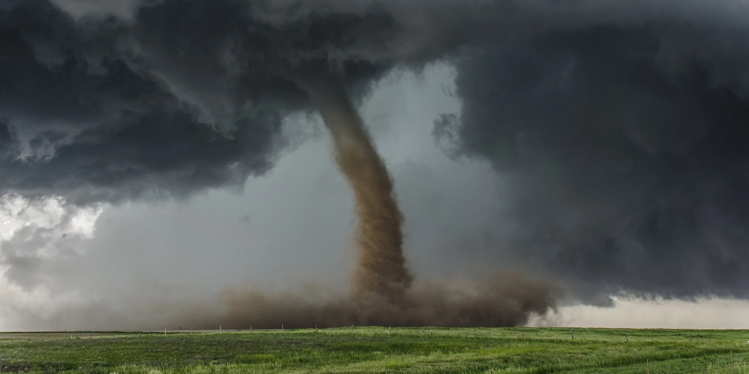 bigstock-Beautiful-tornado-over-a-green-93483716.jpg