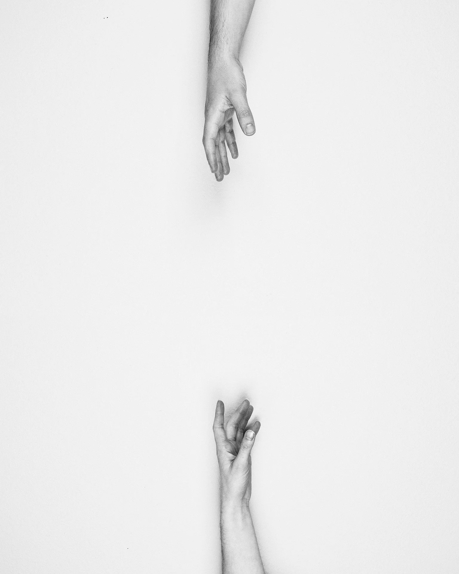 2 hands reaching for each other