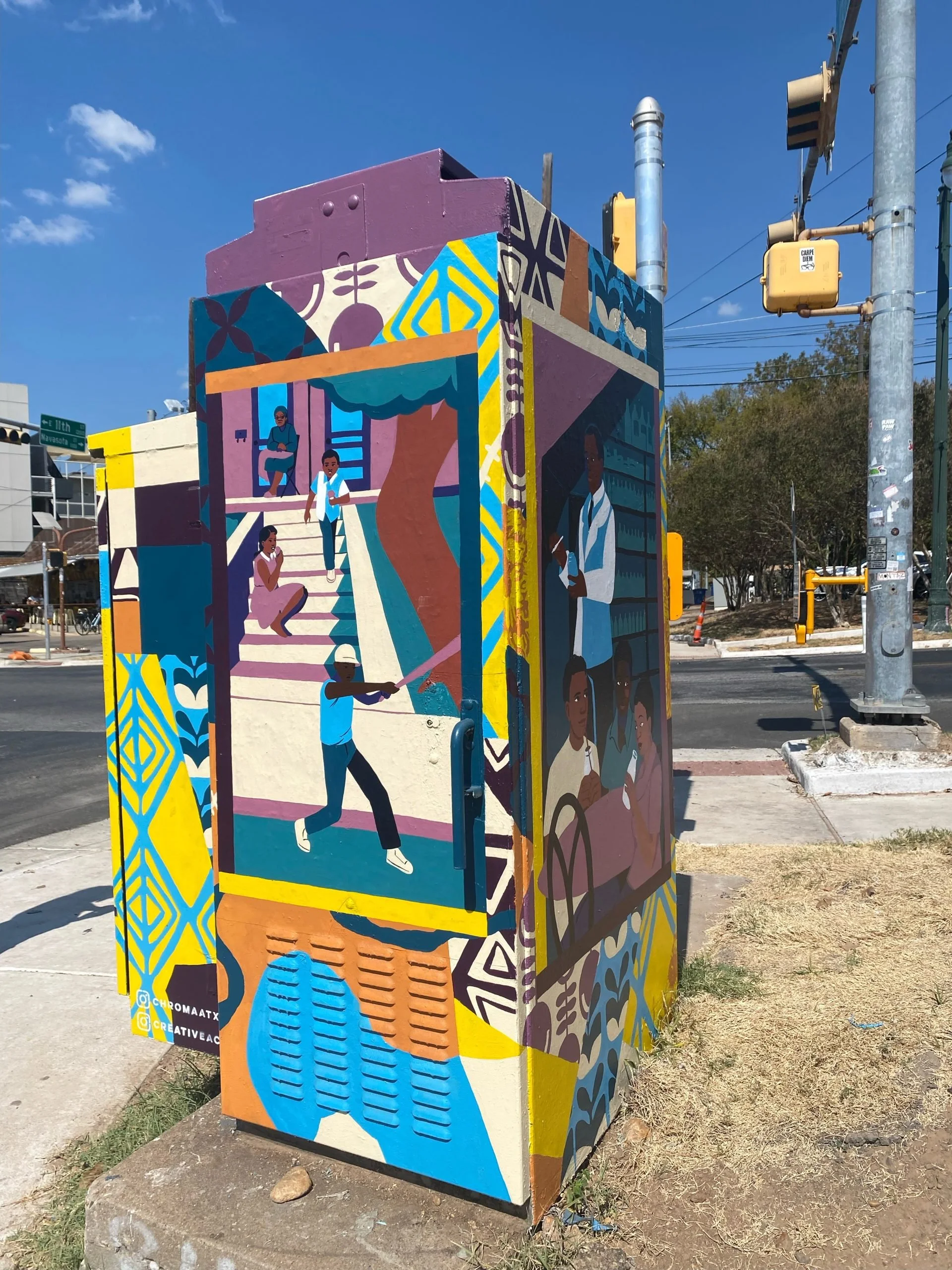 Colorful mural on a utility box depicting diverse people, including a woman sitting on stairs, a woman with a phone, a person holding a leash with a dog, and individuals in a community setting, with decorative patterns and vibrant colors.