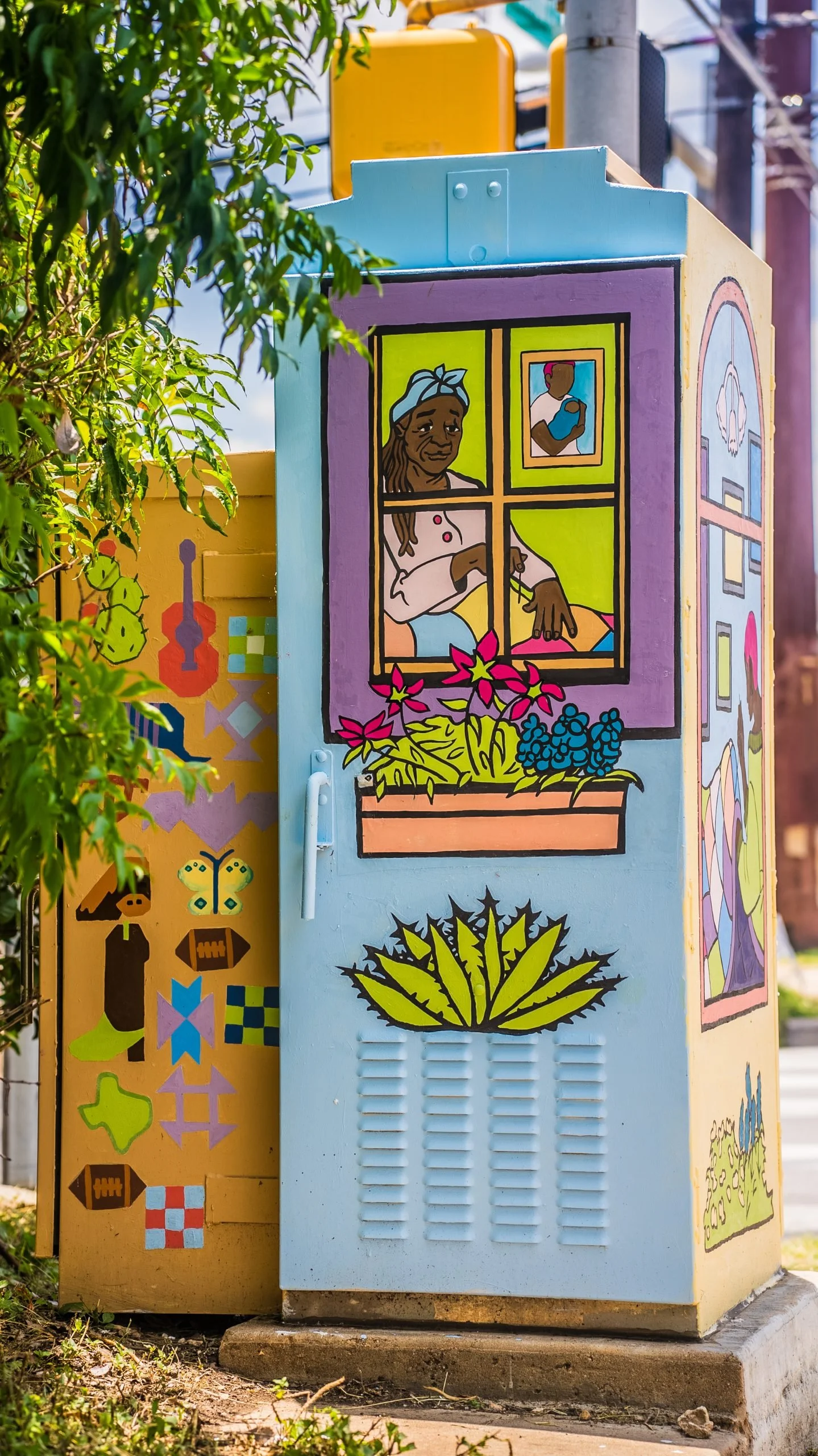 Colorful painted utility box with artwork including a woman looking out a window, a man holding a phone, and various plants and abstract shapes.
