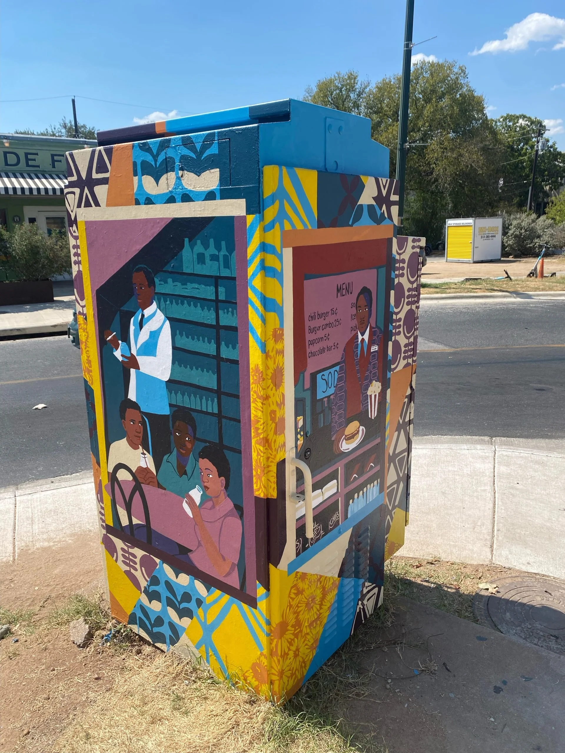 Colorful mural illustrating a convenience store on a utility box, featuring images of diverse people shopping and enjoying food, with a menu and vibrant patterns.