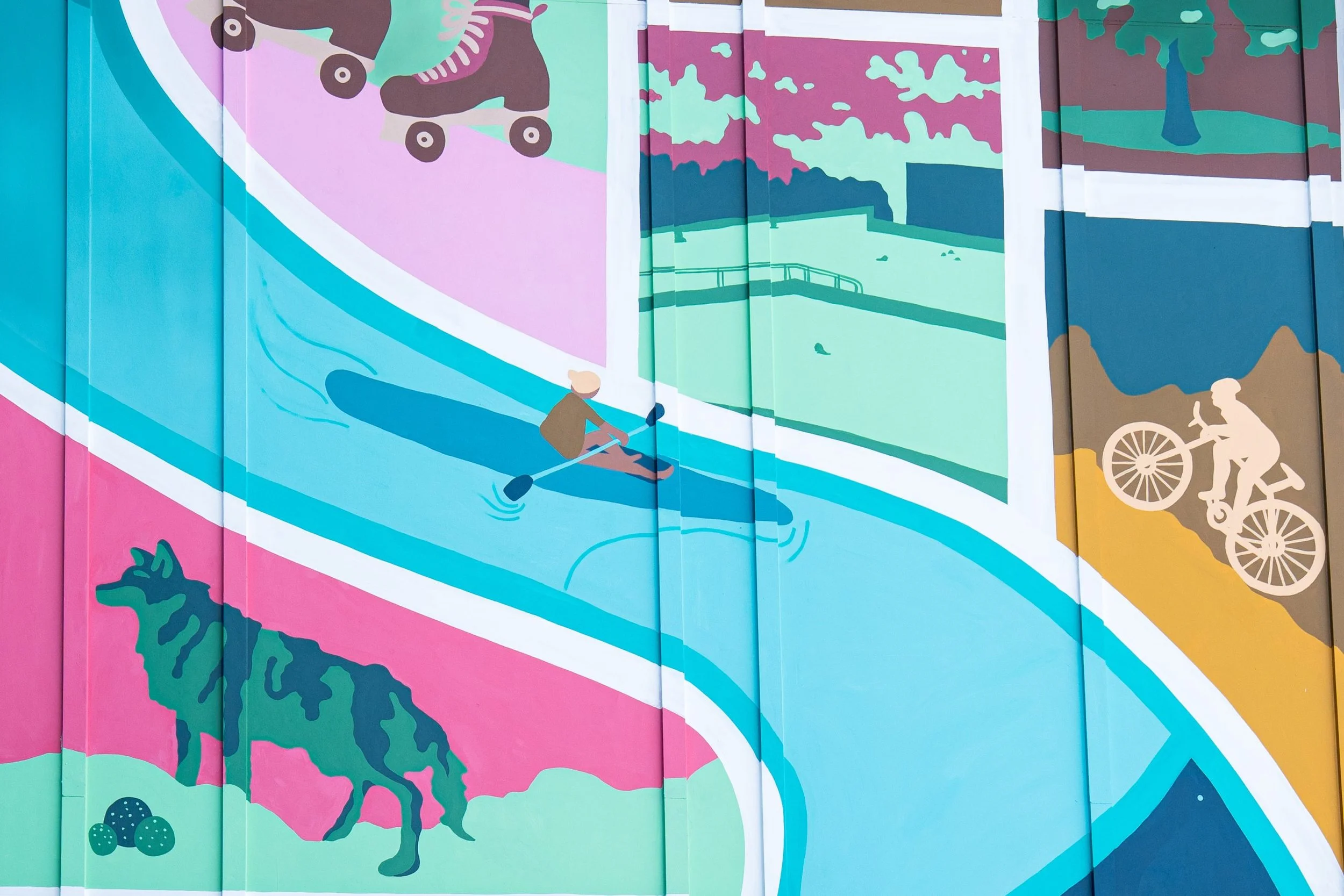 Colorful mural depicting outdoor activities including skateboarding, paddleboarding, biking, and walking, with nature scenery such as trees and water.