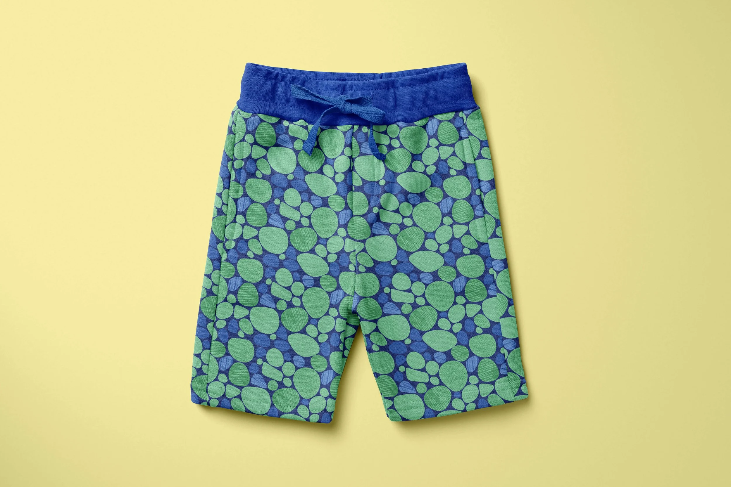 Boys shorts in an organic green and blue pattern that resembles pebbles on the beach.