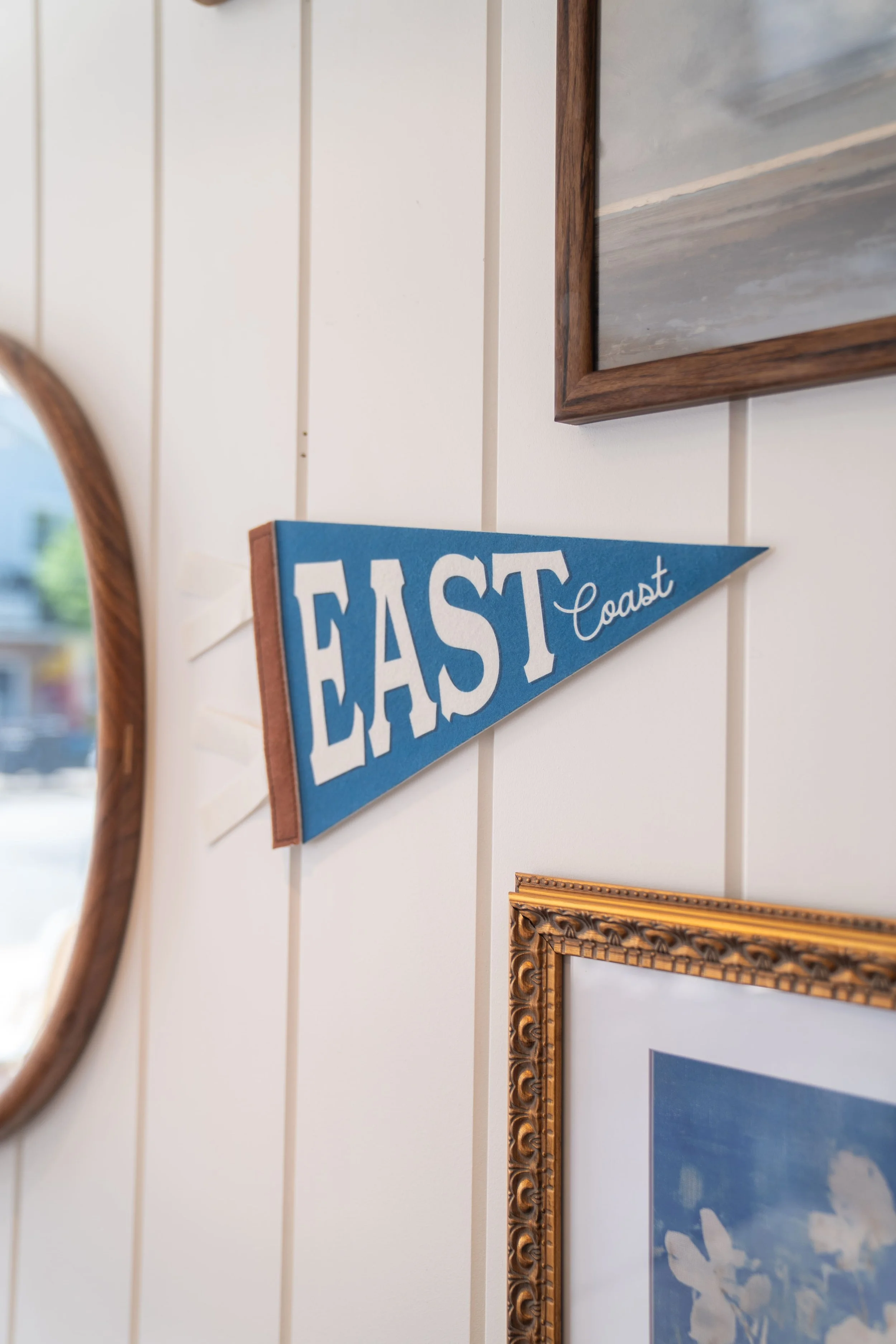 close up photo of a flag hanging on landmark cafe's wall titled "east coast"
