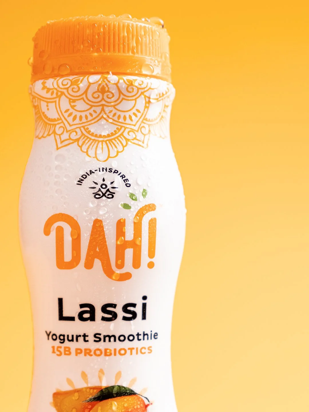Commercial beverage photography of a small portable bottle of Dah! Lassi yogurt smoothie drink, cleanly styled for a product campaign and brand marketing.
