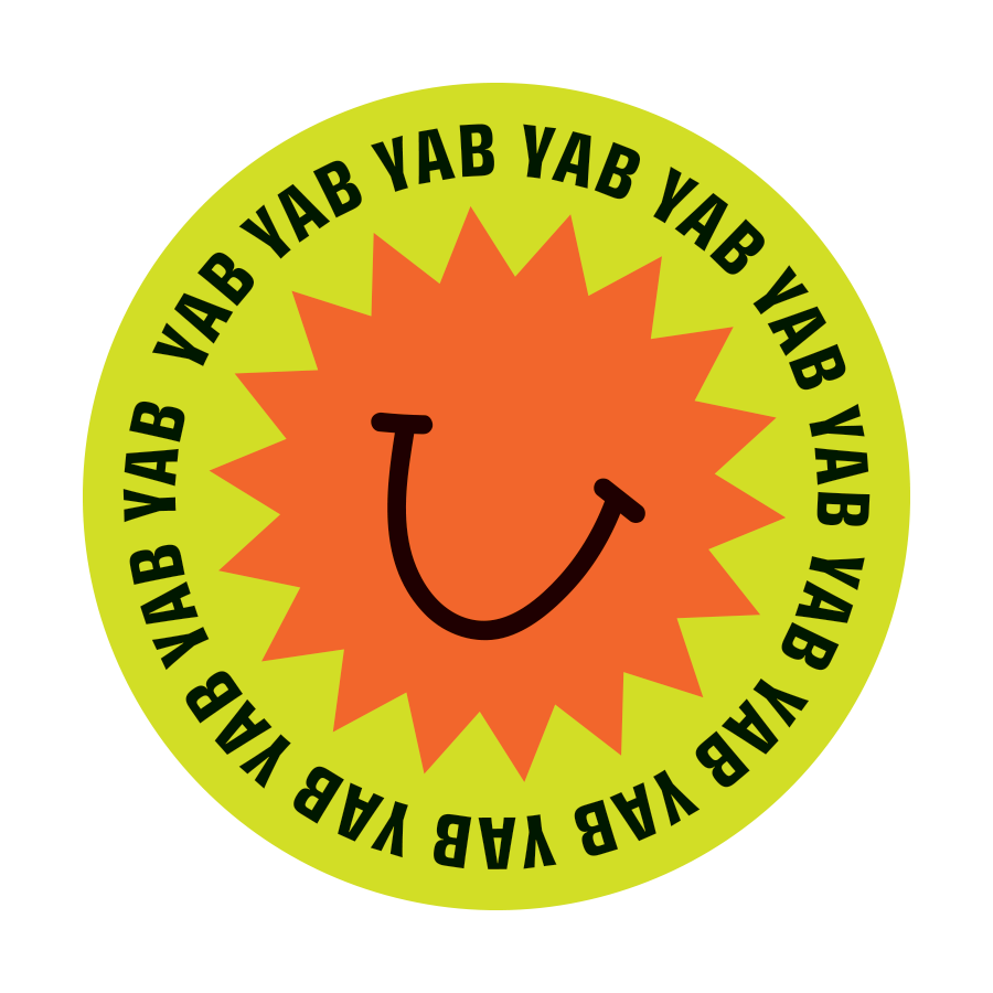 A circular graphic with a lime green border containing the repeated black text 'YAB YAB YAB YAB YAB' around the edge. Inside the circle, there is an orange starburst shape with a cartoon smiling face and a simple black curved line for a mouth.