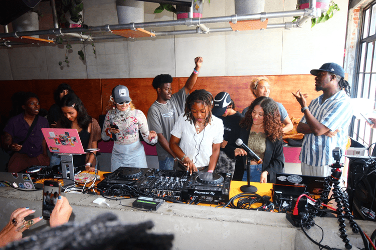 Young DJs and a crowd at a Building Beats event