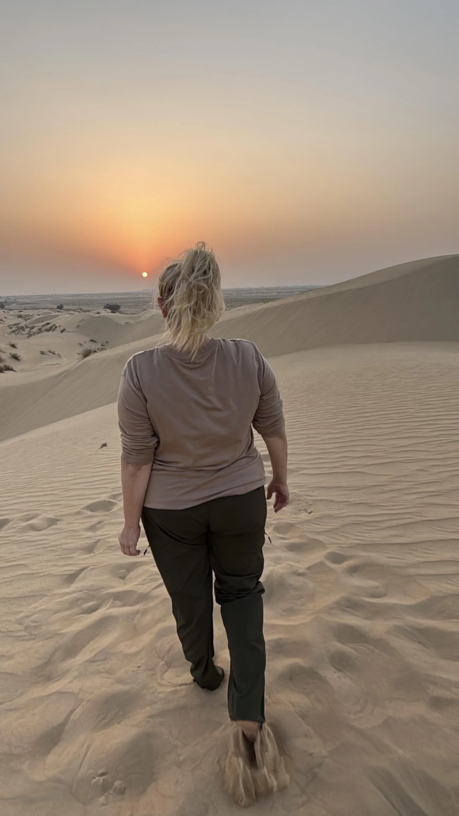 Jeanine With Lavishly Travel in Dubai in the desert at sunset adventure