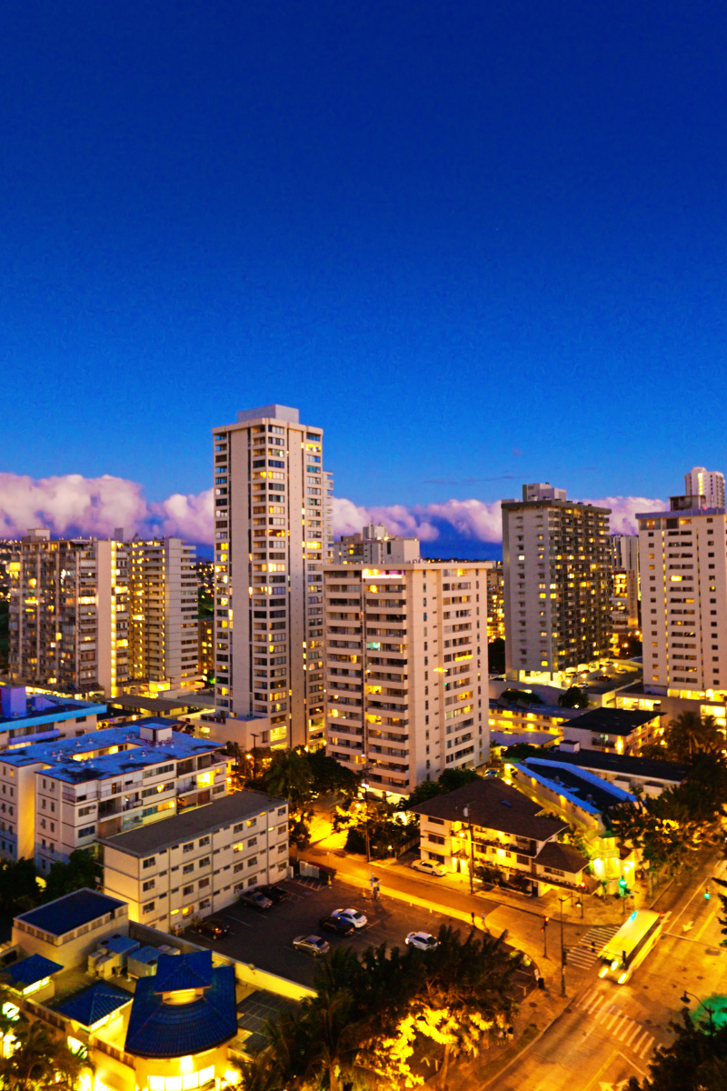 Illuminated Honolulu high-rise buildings at dusk on Oahu