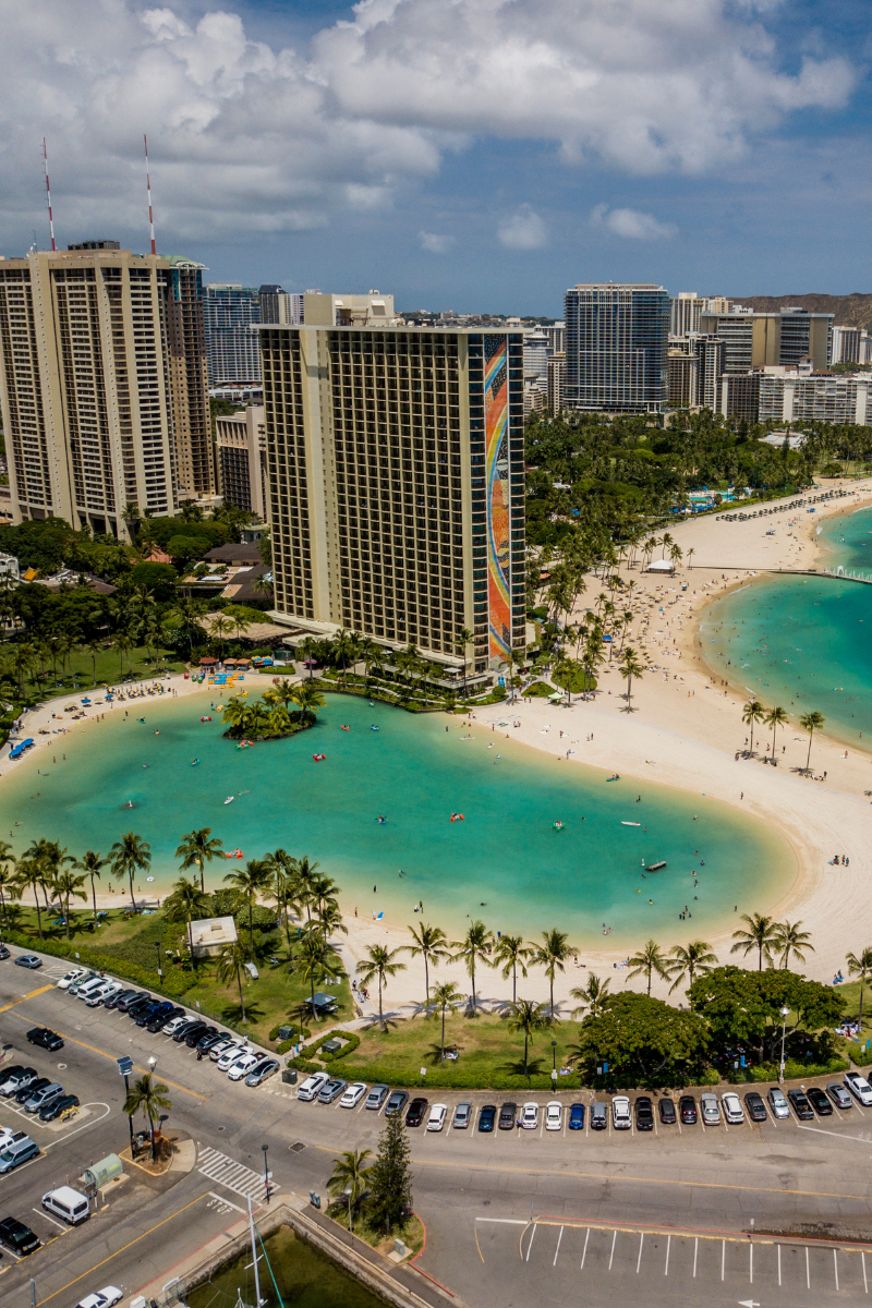 Oahu beachfront resort buildings surrounding a turquoise lagoon