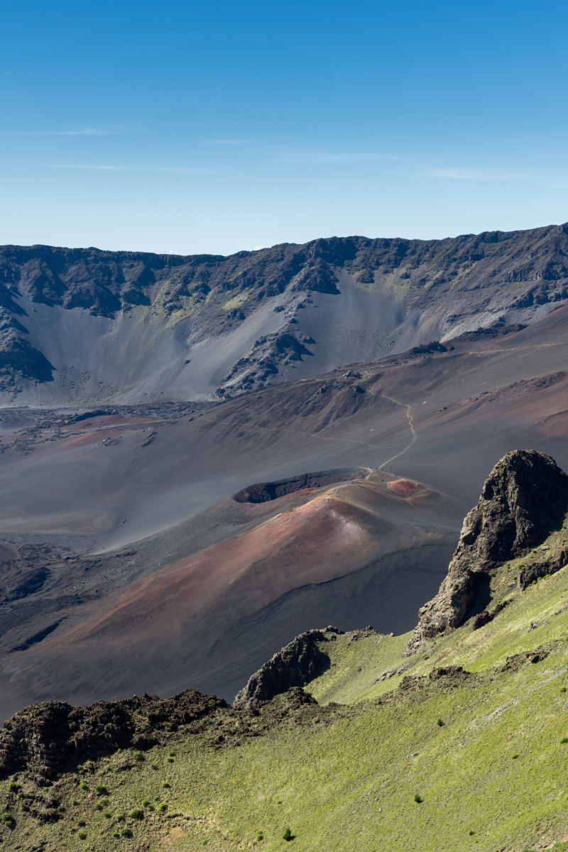 Colorful volcanic cinder cones and rocky slopes inside Haleakala crater on Maui