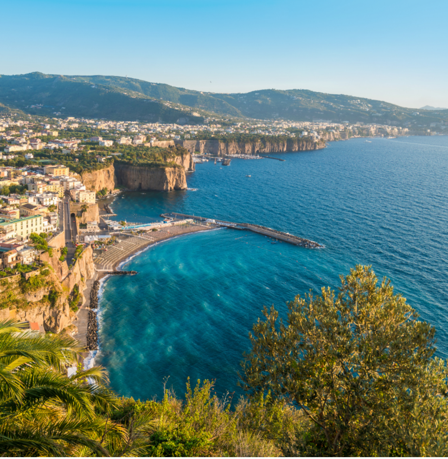 Clifftop town and shoreline overlooking the blue sea in southern Italy.