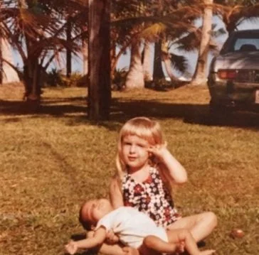 Vintage photo of a young girl, Jeanine, in American Samoa, 1973, reflecting a lifelong passion for global travel.