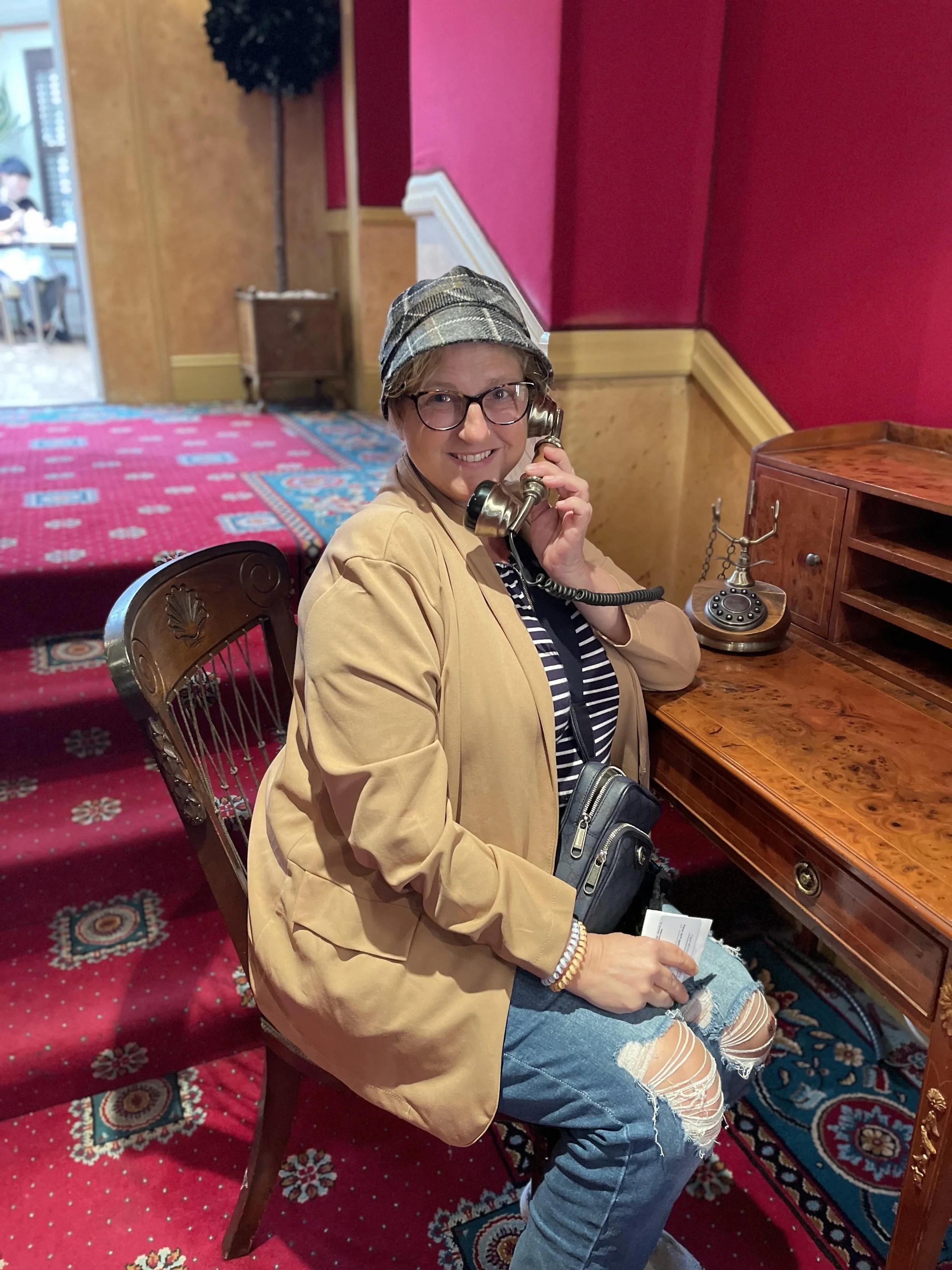 Jeanine Lavishly Travel in London on an old phone looking more like Sherlock Holmes