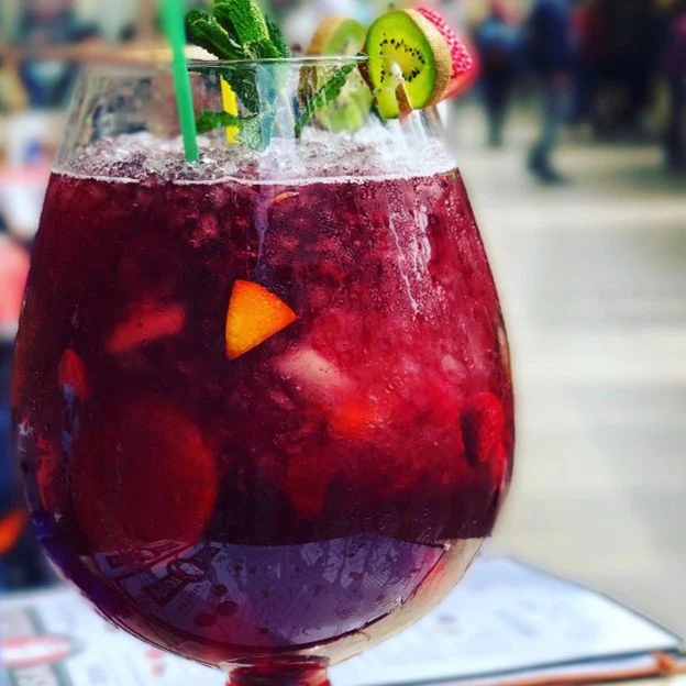 Glass of red sangria garnished with fresh fruit