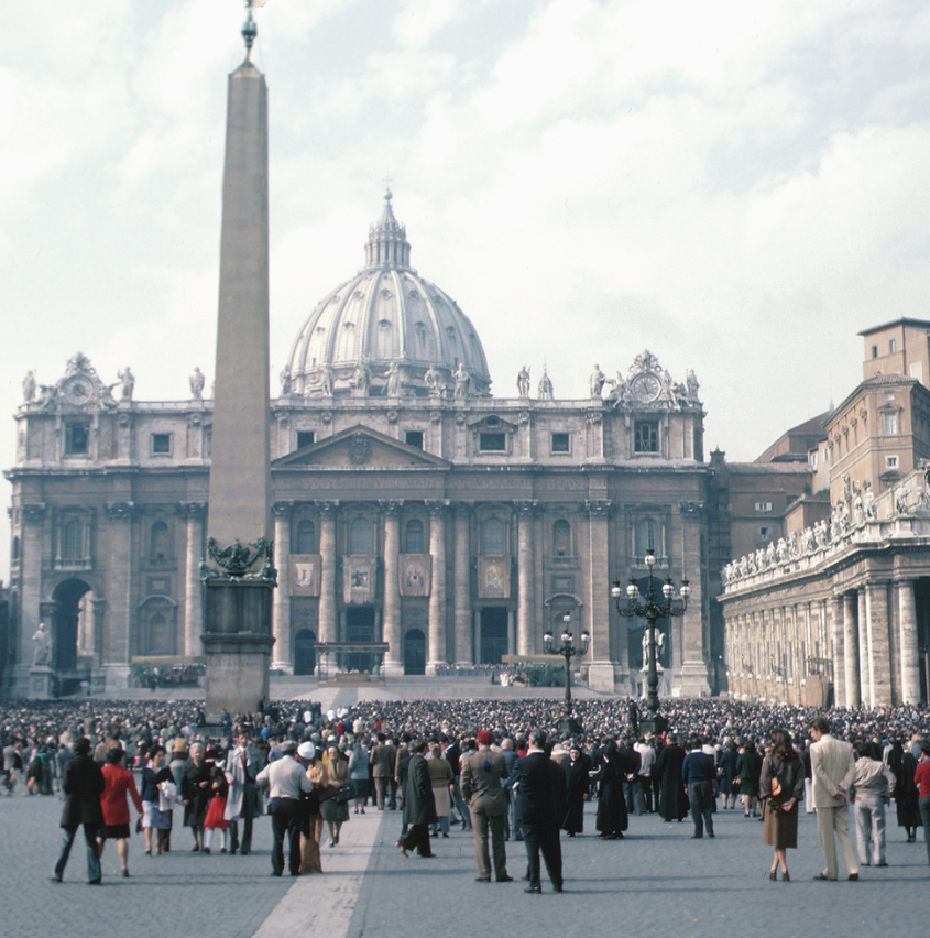 Crowd in St. Peter’s Square with St. Peter’s Basilica dome and Vatican obelisk in Rome, Italy
