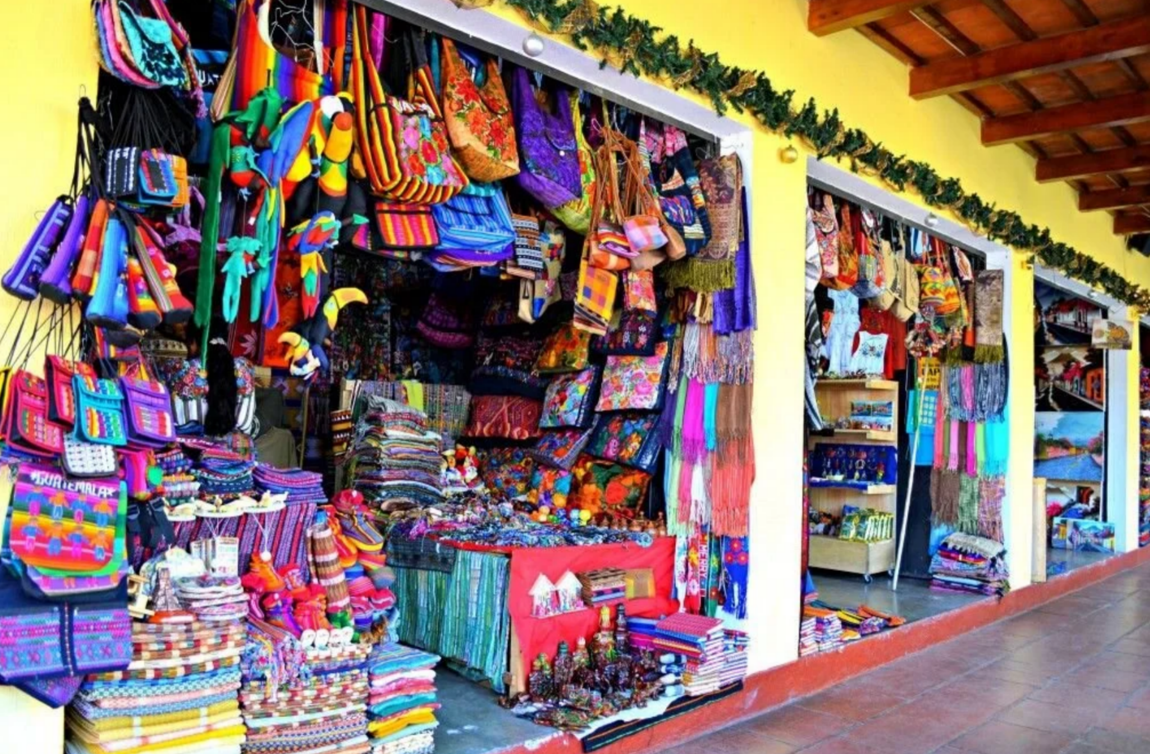 Vibrant Caribbean market filled with colorful handmade bags, textiles, artisan crafts, and local souvenirs in Antigua.