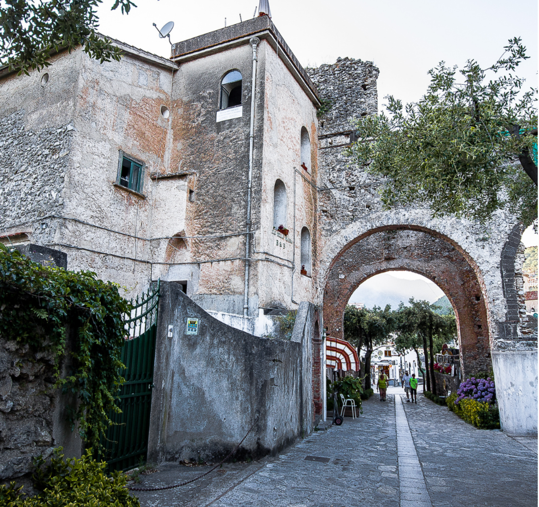 Historic stone archway and charming streets of Ravello, Italy, with lush gardens and terraces hosting intimate performances and art installations during the Ravello Music and Arts Festival on the Amalfi Coast.