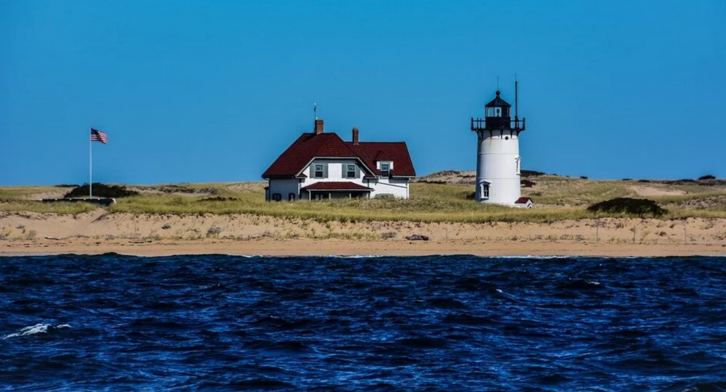 Timeless coastal charm: discovering historic lighthouses tucked along the picturesque, wind-swept sand dunes of Cape Cod.