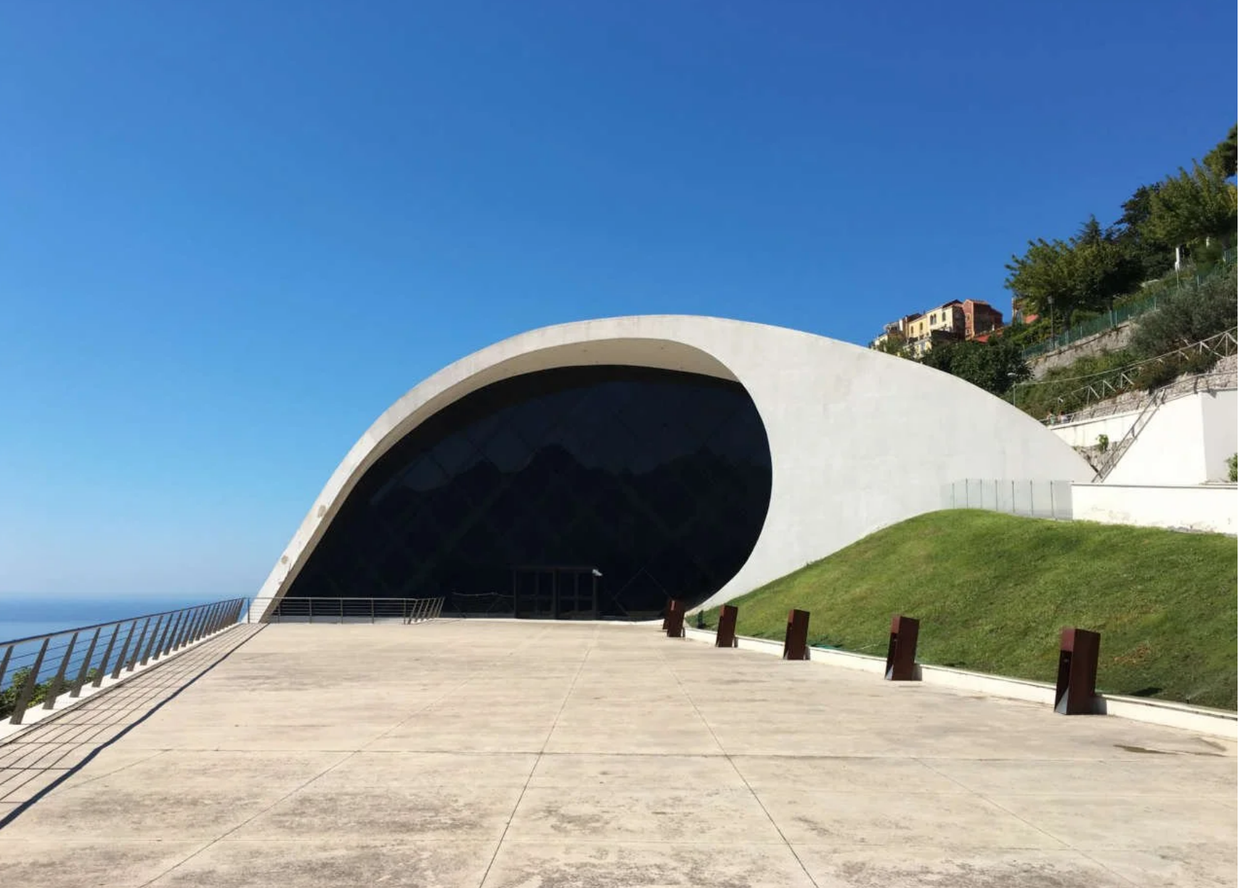 Ravello Auditorium on the Amalfi Coast, a modern venue designed by Oscar Niemeyer, featuring a curved white structure overlooking the Mediterranean and hosting performances during the Ravello Music and Arts Festival.