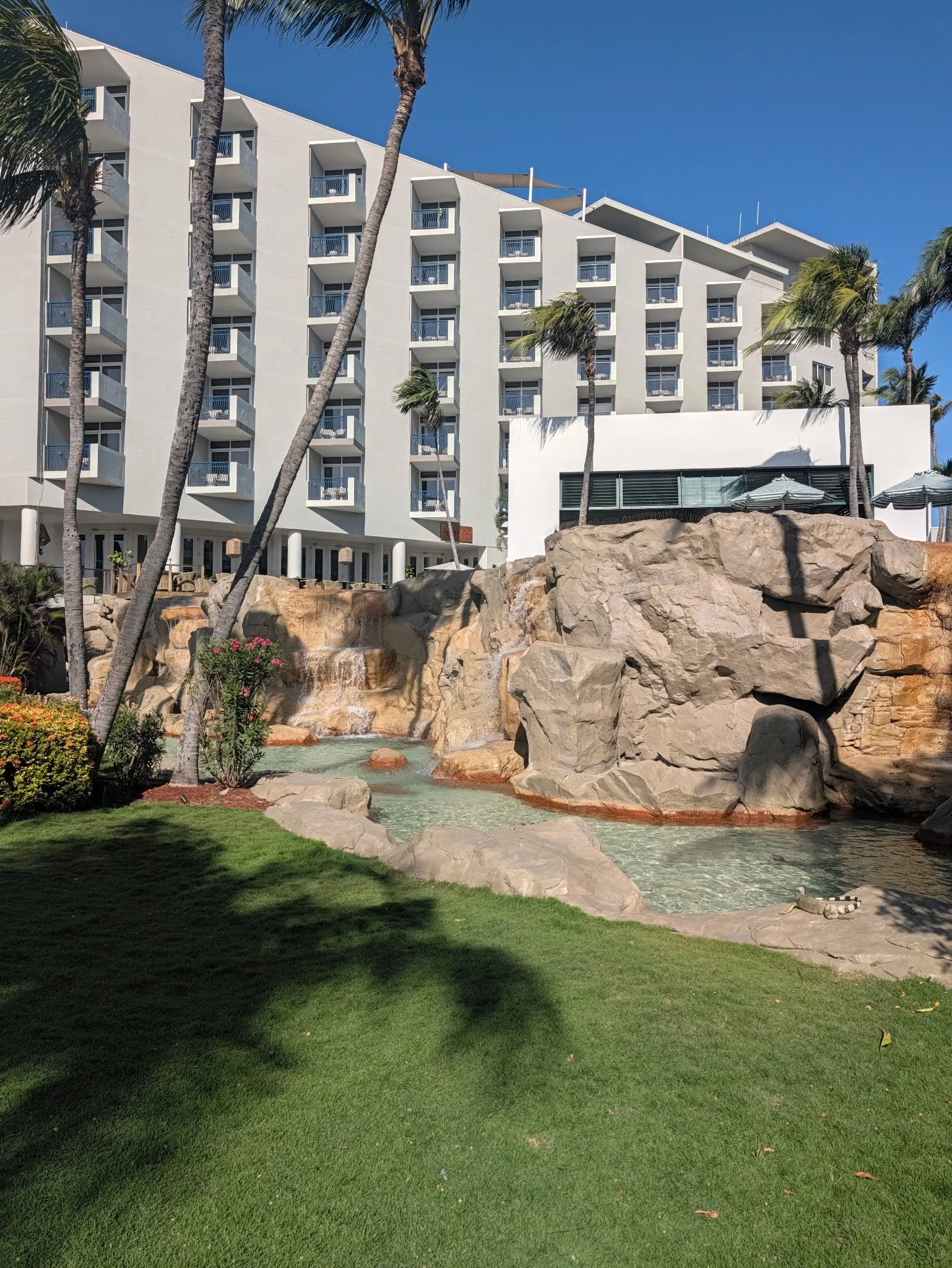 Rock waterfall and tropical gardens on the grounds of Hilton Aruba Caribbean Resort & Casino