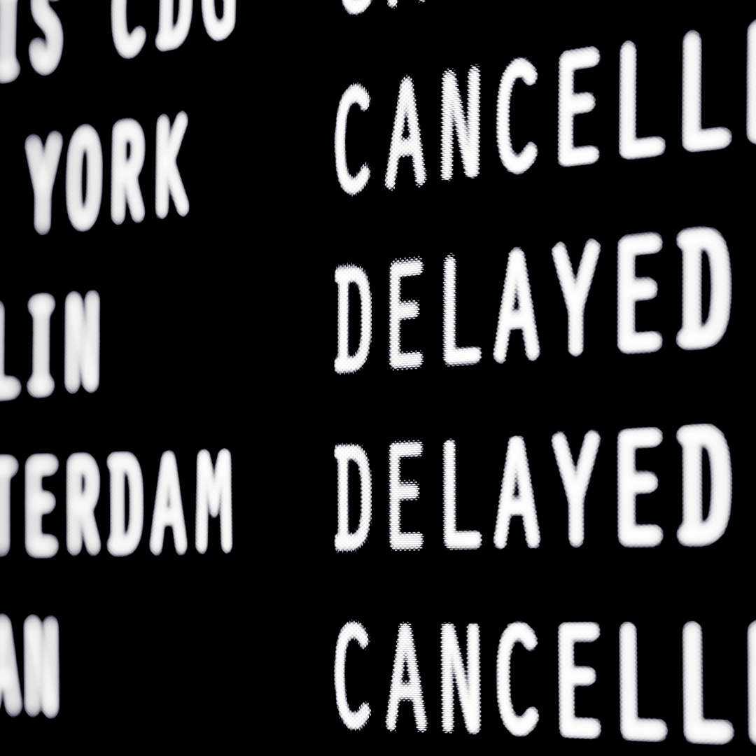A flight status board displaying canceled and delayed flights, highlighting the common frustrations of air travel disruptions.