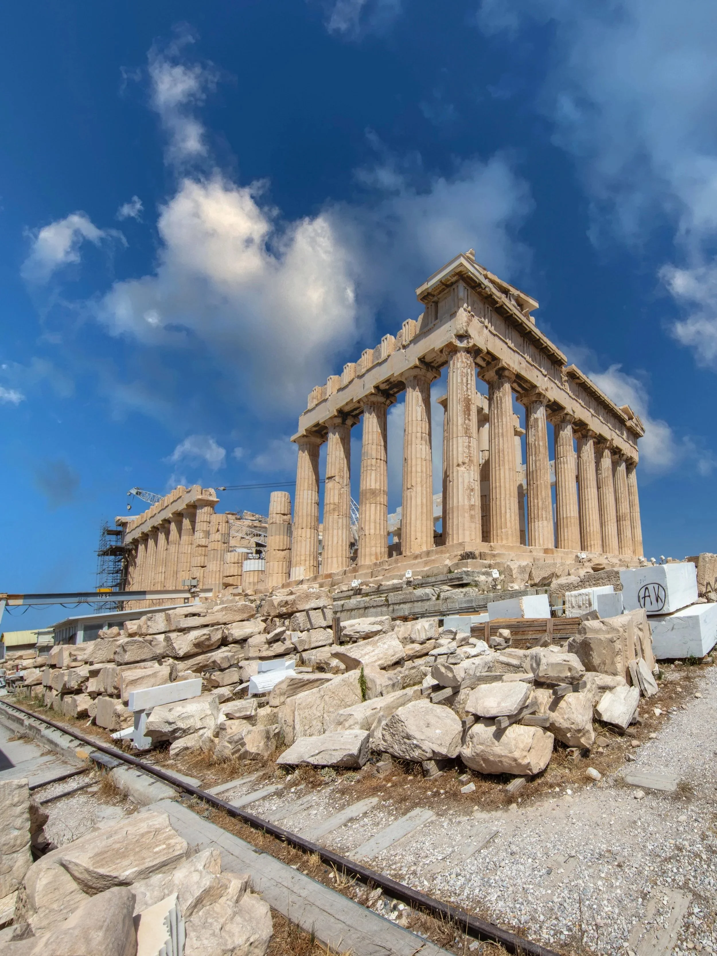 The ancient Parthenon temple at the Acropolis in Athens under a blue sky, showcasing historical luxury tours in Greece with Lavishly Travel.