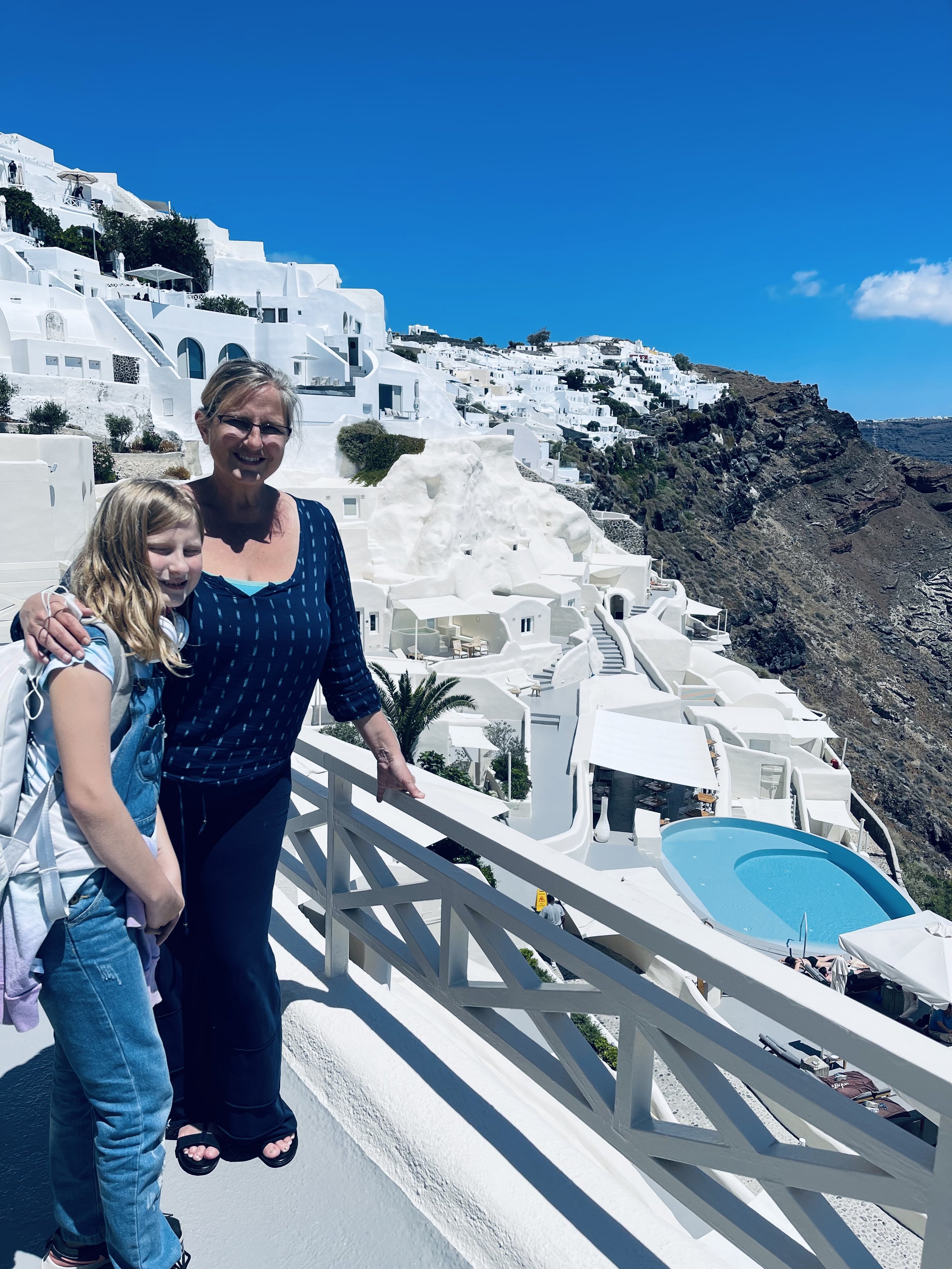 Jeanine and her daughter overlooking the Santorini caldera in Greece