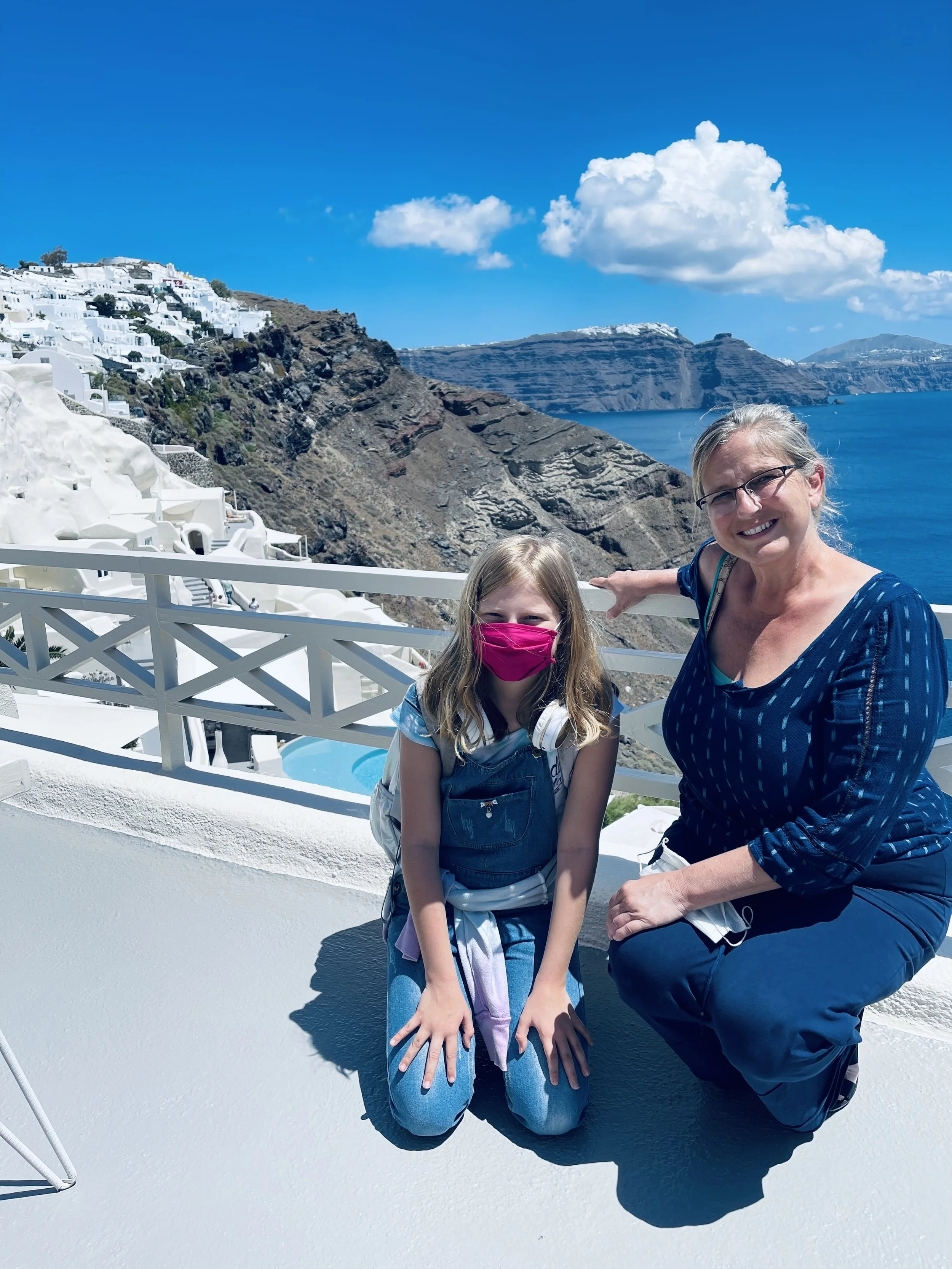 Jeanine Cioffi and a family member overlooking the Santorini caldera during their Greece travels.