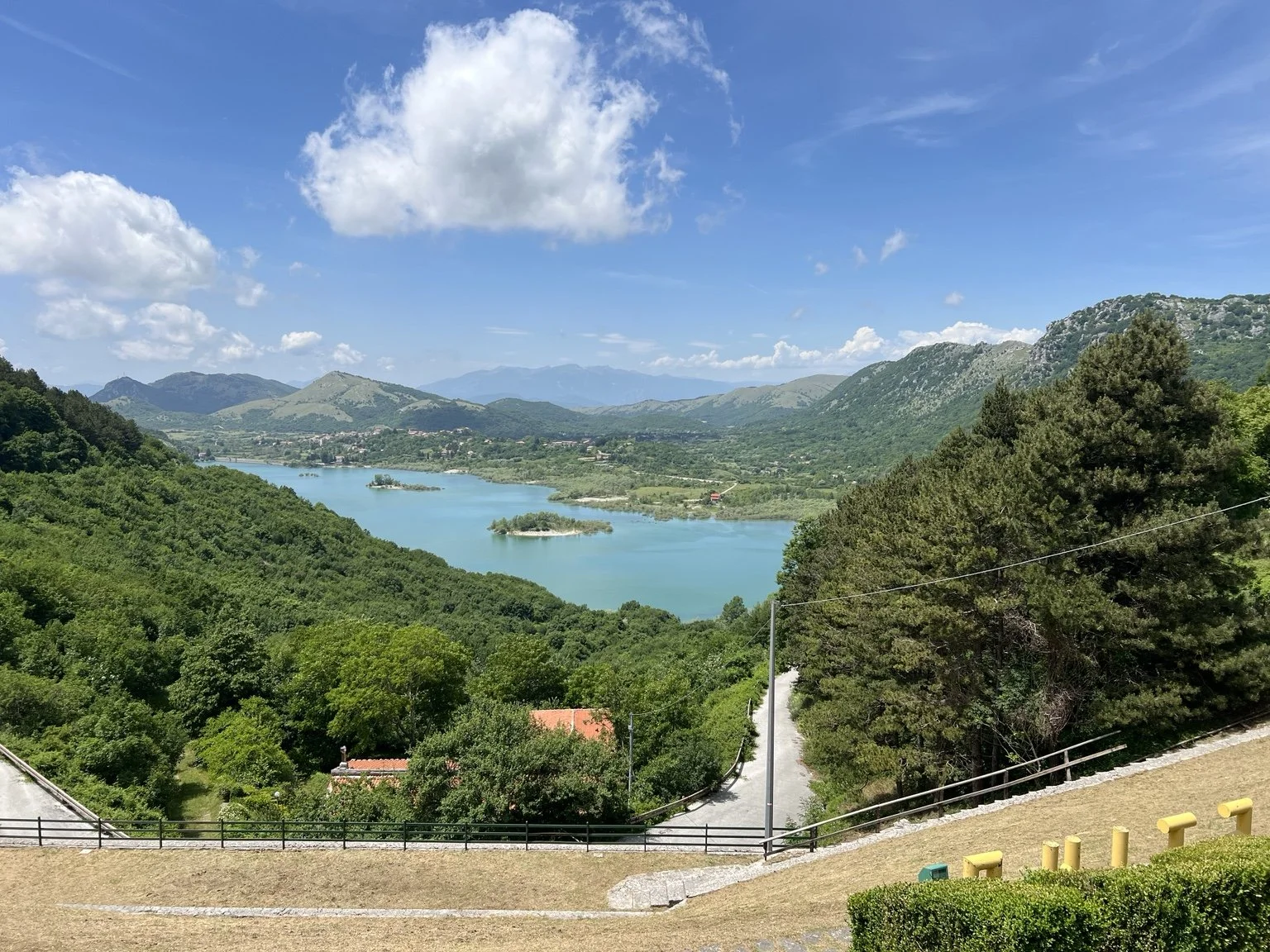 Lago di Gallo surrounded by green hills in the family-roots area of Italy.