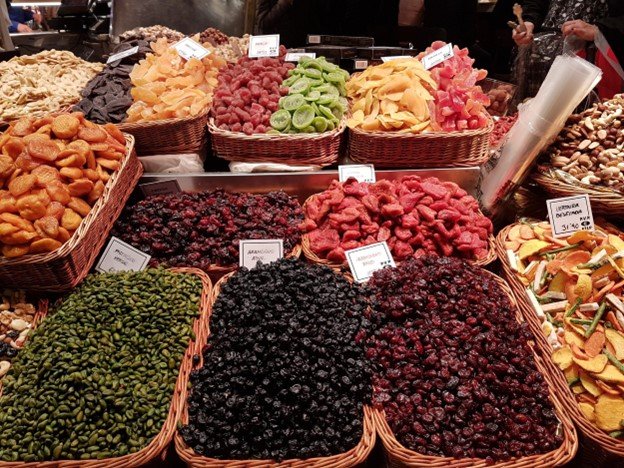 Baskets of dried fruits and nuts at a Barcelona food market