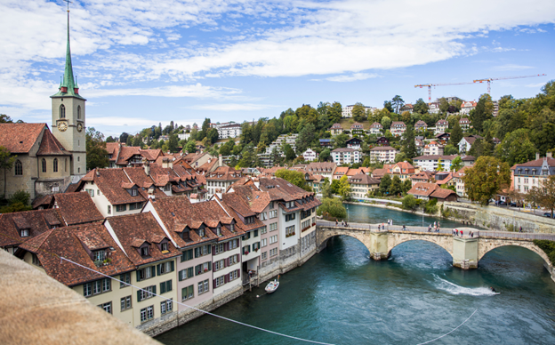 Bern old town rooftops and a stone bridge over the Aare River, a short train ride from Basel