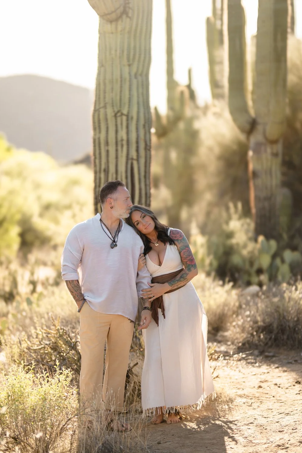 Breathwork facilitators standing near cacti in desert landscape