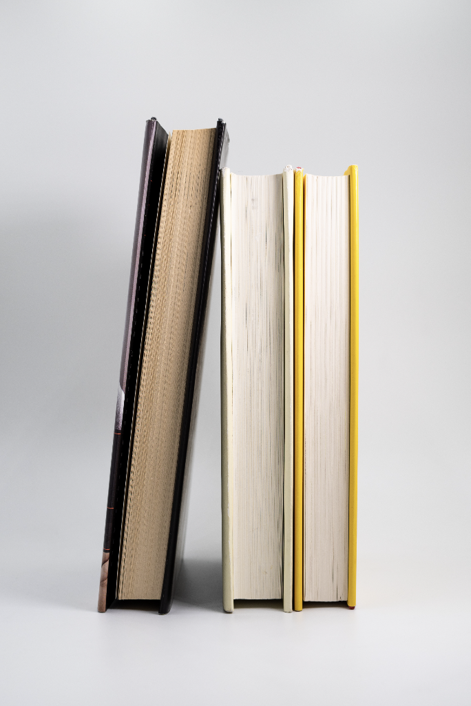 Vertical book stack standing against white background