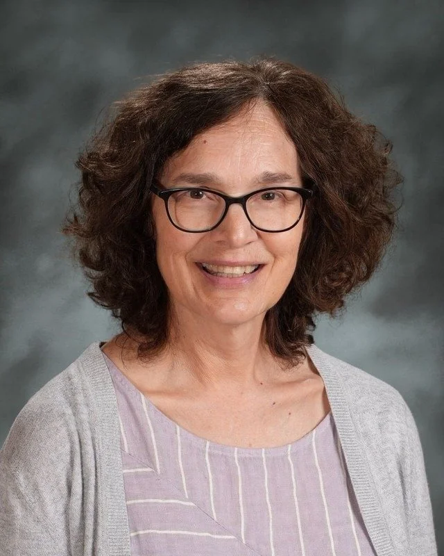 A school crest with religious symbols and a female figure with a halo, and the phrase 'Coming Soon' below.