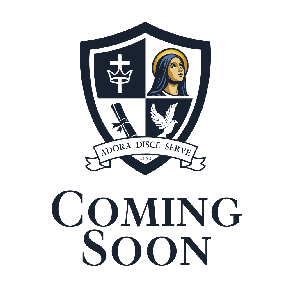 A school crest featuring a shield divided into four sections with a cross, a stylized crown, a woman with a halo, a diploma scroll, and a dove. Beneath the shield is a banner with the Latin phrase "Adora Disce Serve" and the year "1983." Below that, the text reads "Coming Soon."