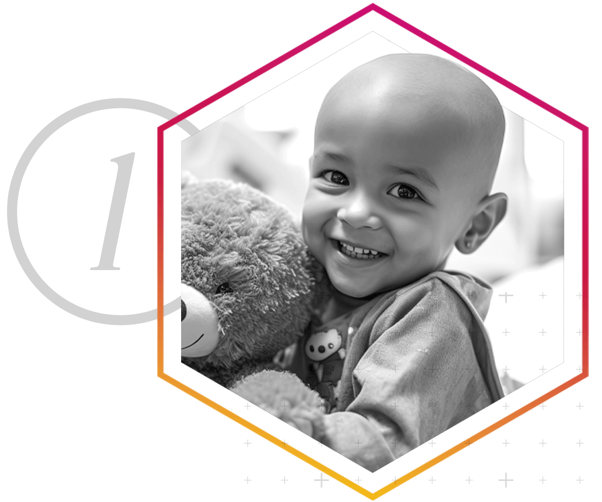 A smiling boy holding his teddy bear.